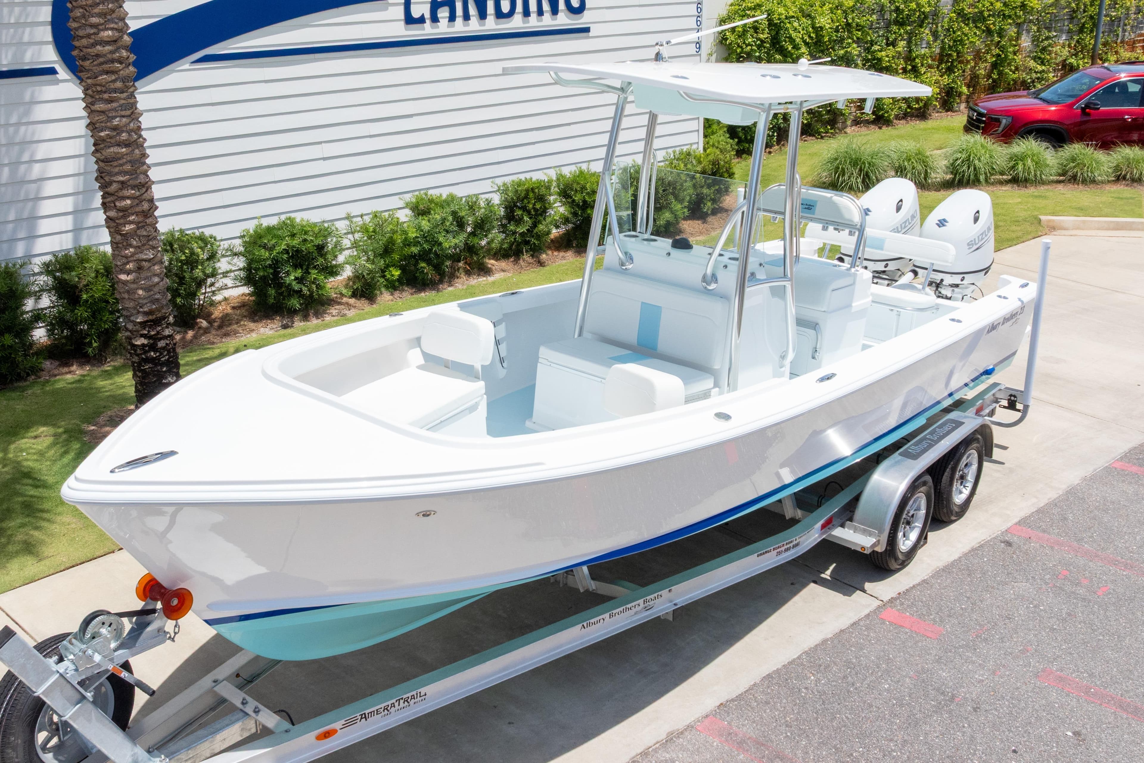2026 Albury Brothers 23 Forward Seating boat on trailer, parked outdoors.