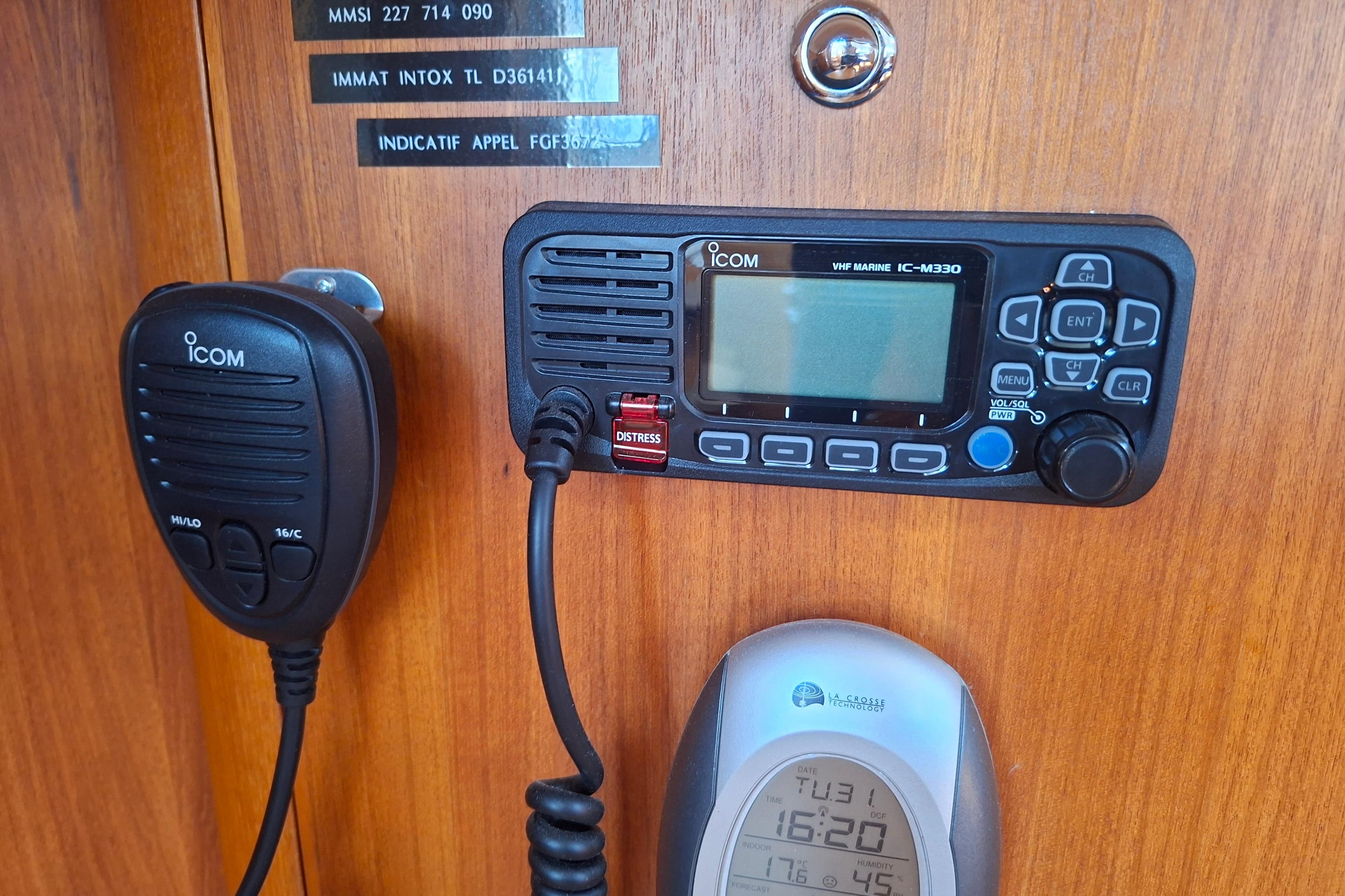 ICOM VHF marine radio and microphone on 2006 Xyachts X 40 wooden panel.
