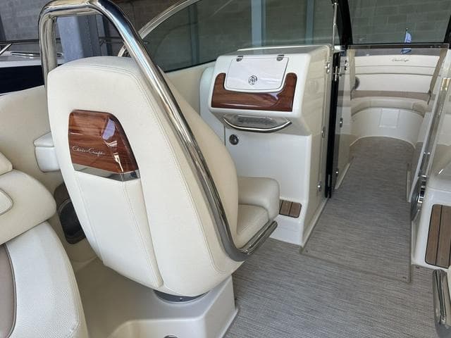 Luxurious interior of 2025 Chris-Craft Launch 28 GT boat with elegant seating and wood accents.