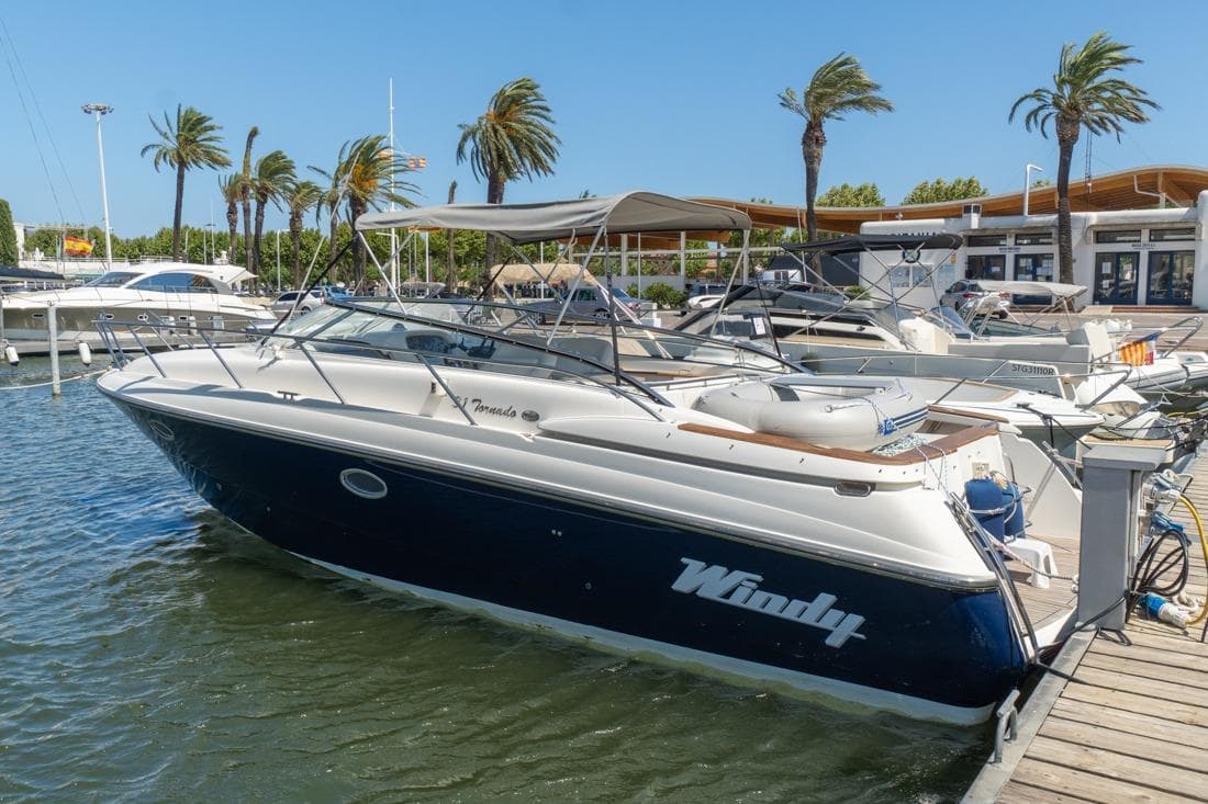 2001 Windy 31 Tornado boat docked at marina with palm trees in background.