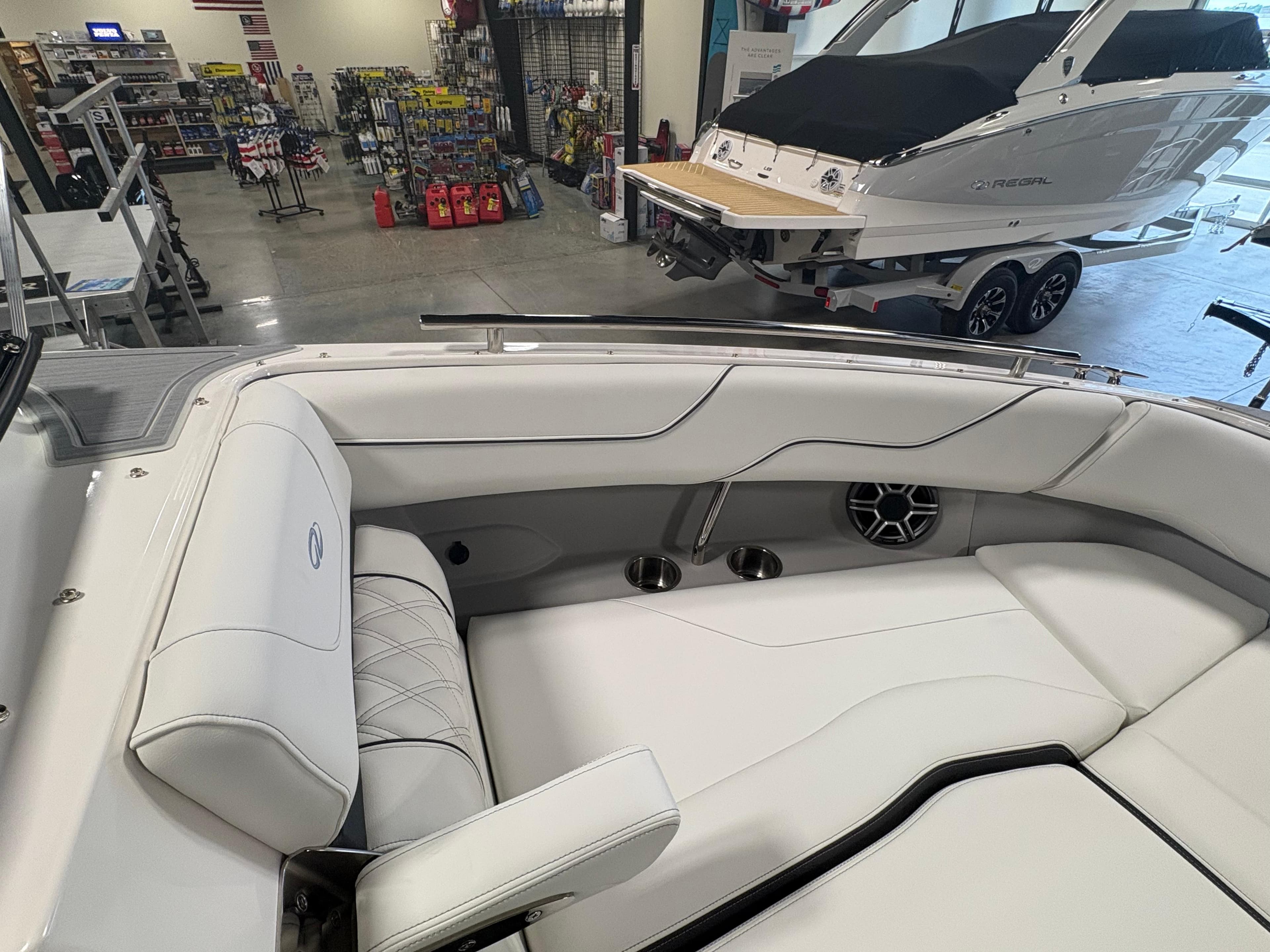 2026 Regal LS6 Surf boat interior with white seating in showroom.
