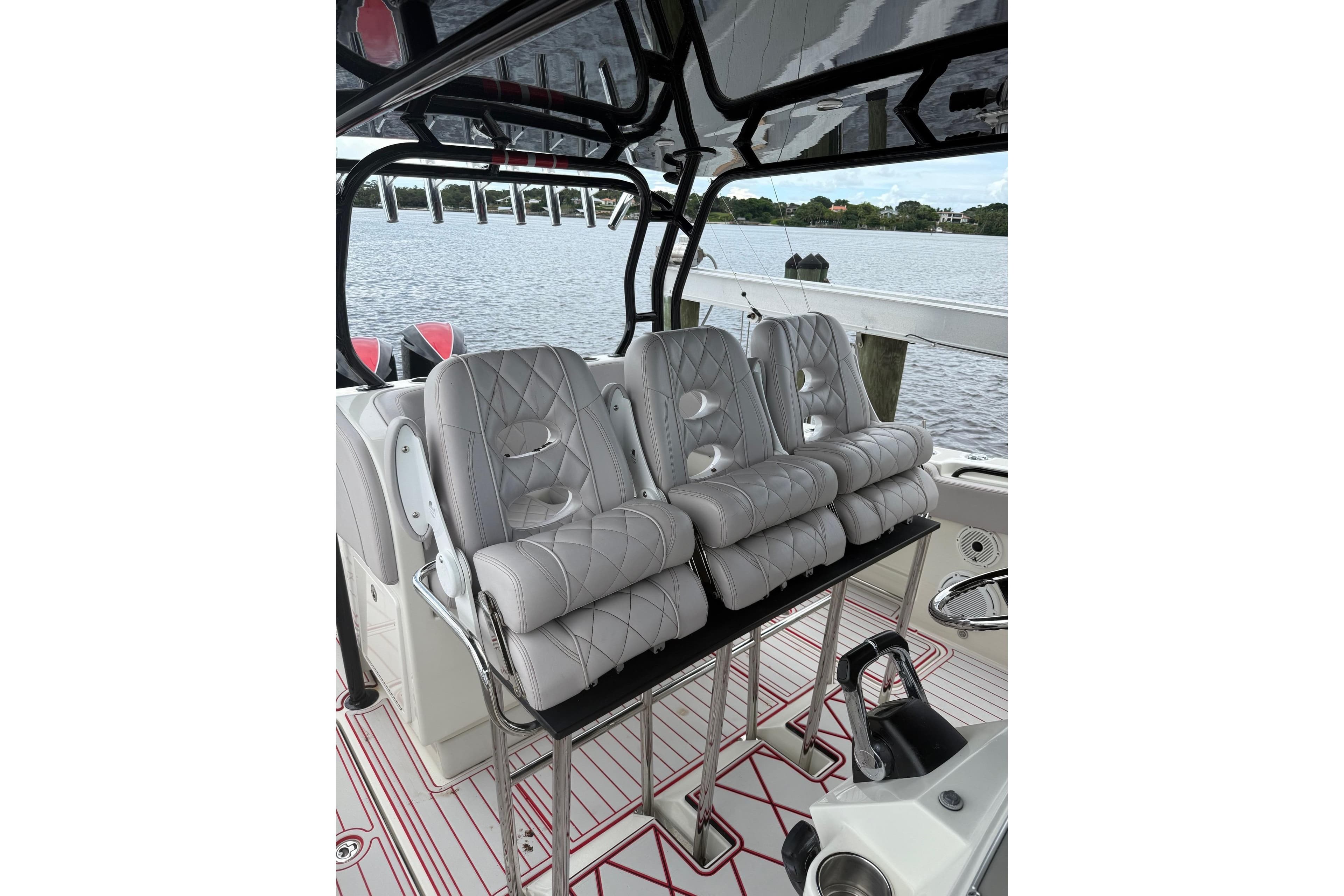 Luxurious seating on 2013 Hydra-Sports 42 boat, featuring quilted leather design and scenic water view.