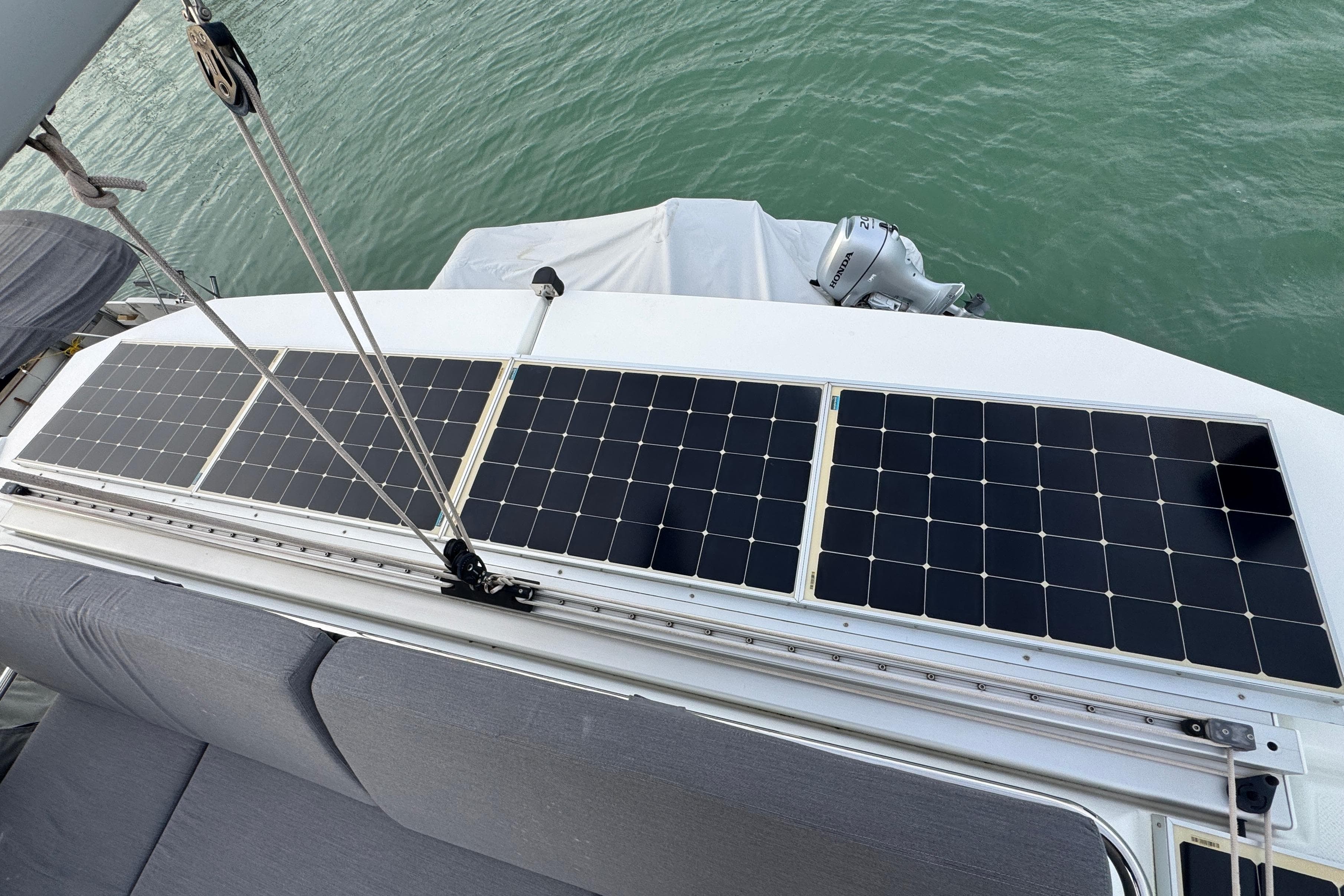 Solar panels on a 2021 Fountaine Pajot Saona 47 catamaran, docked on calm water.