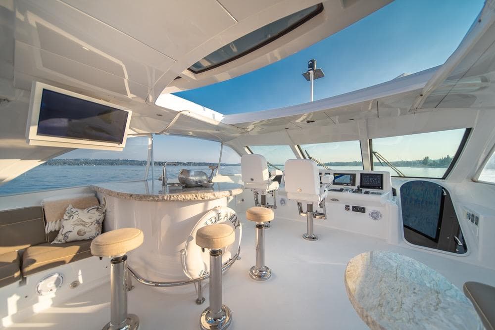 Luxurious 2008 Hatteras 72 Motor Yacht interior with bar, seating, and navigation area.