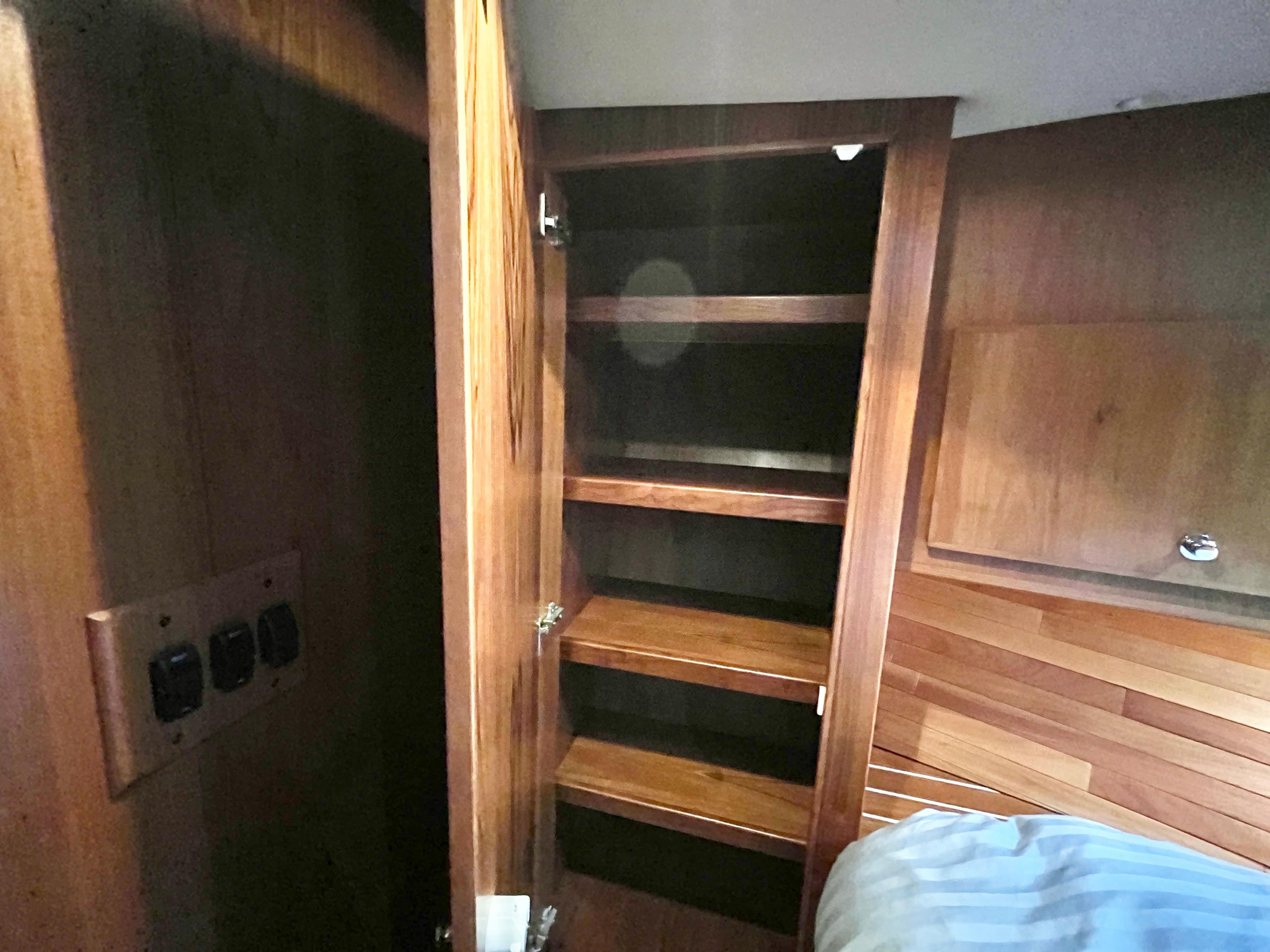 Interior of 2007 Coastal Craft 36 Cruiser showing wooden storage shelves.