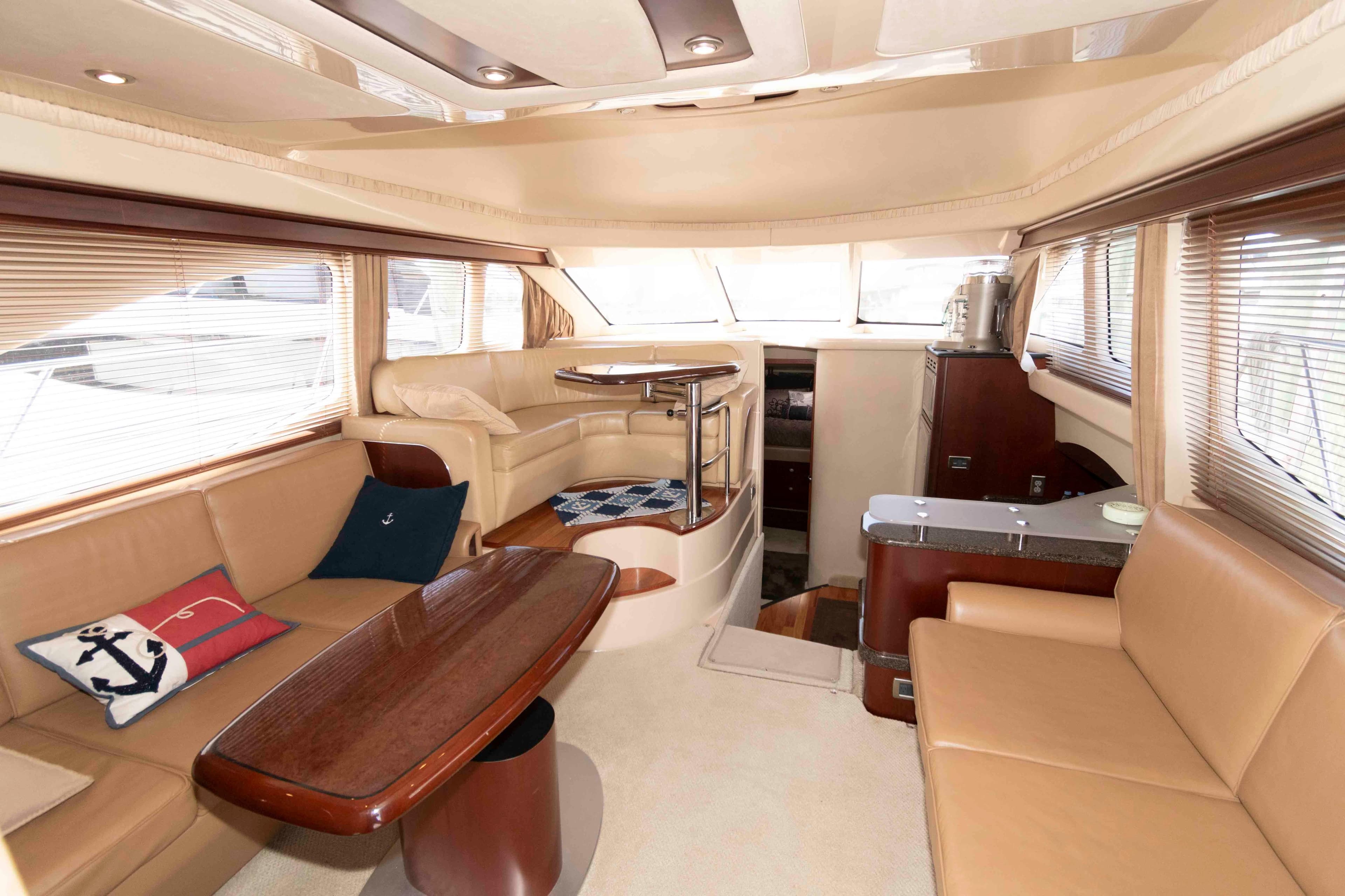 Luxurious interior of 2005 Sea Ray 420 Sedan Bridge yacht with elegant seating and decor.