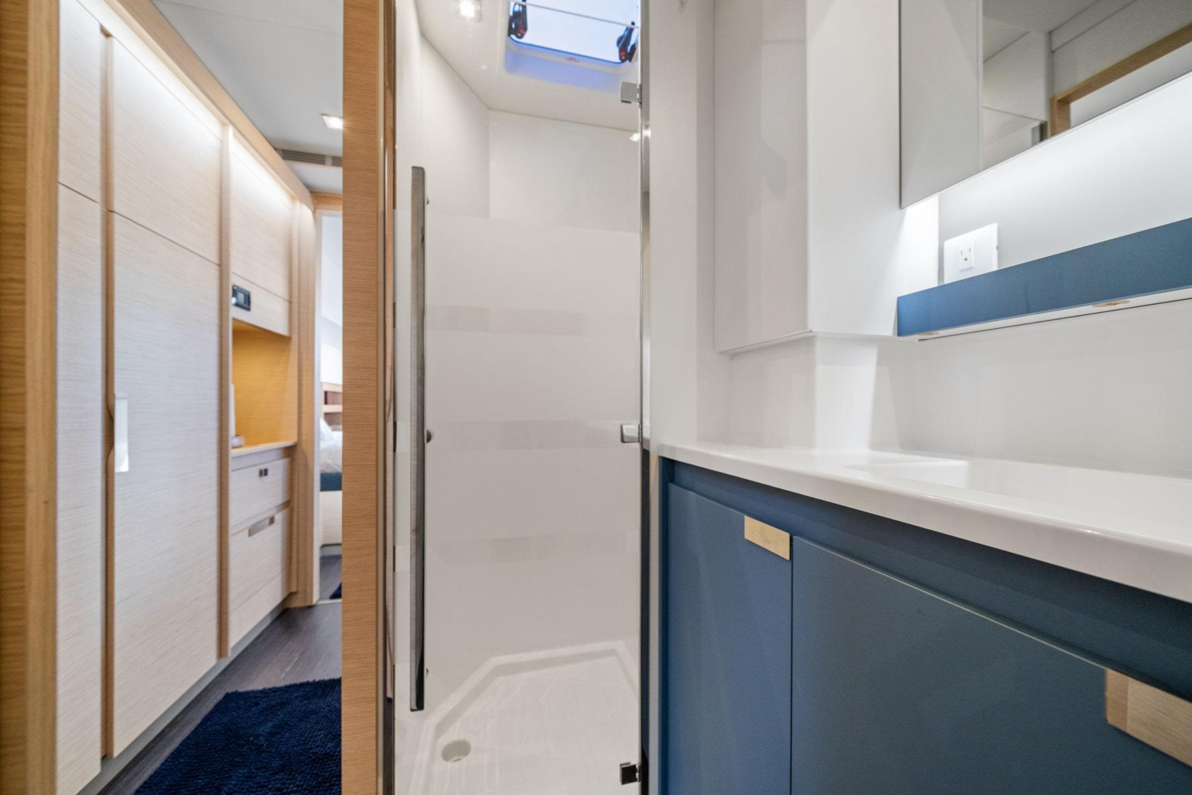 2024 Fountaine Pajot Aura 51 Catamaran interior, featuring modern bathroom and hallway design.
