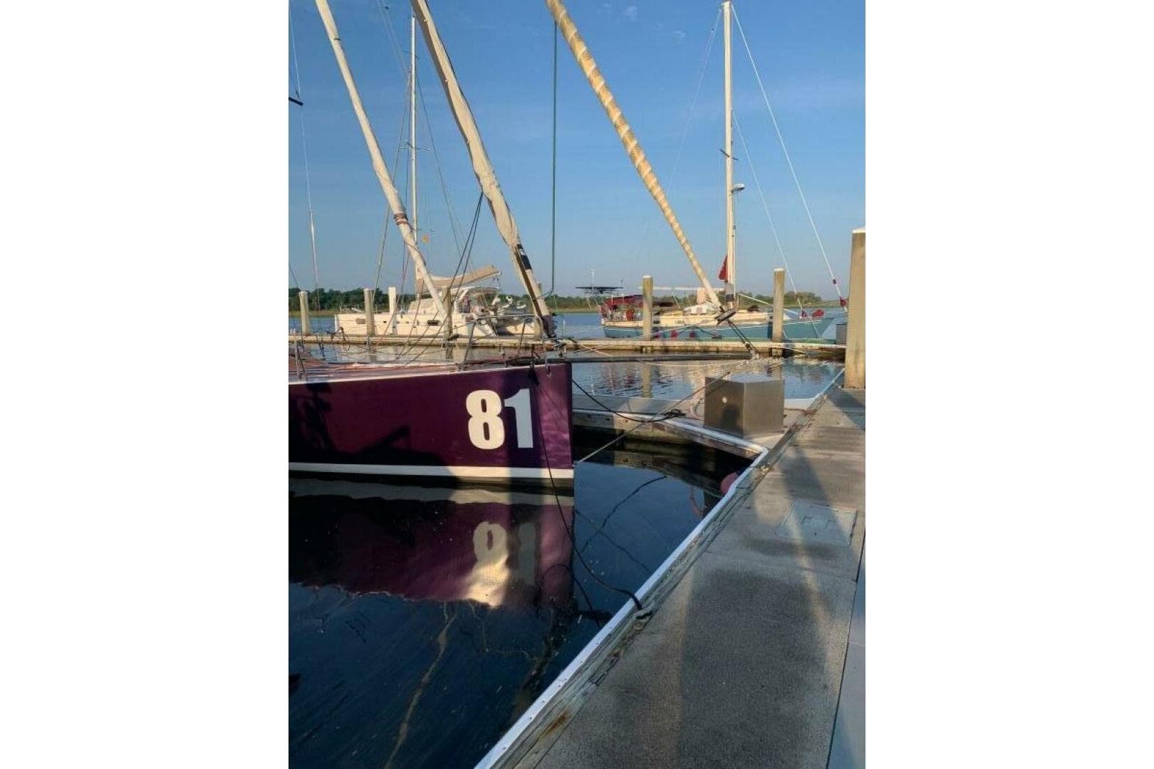 Sailboat "81" docked, Class 40 Akilaria RC2, 2009 model, in a marina setting.