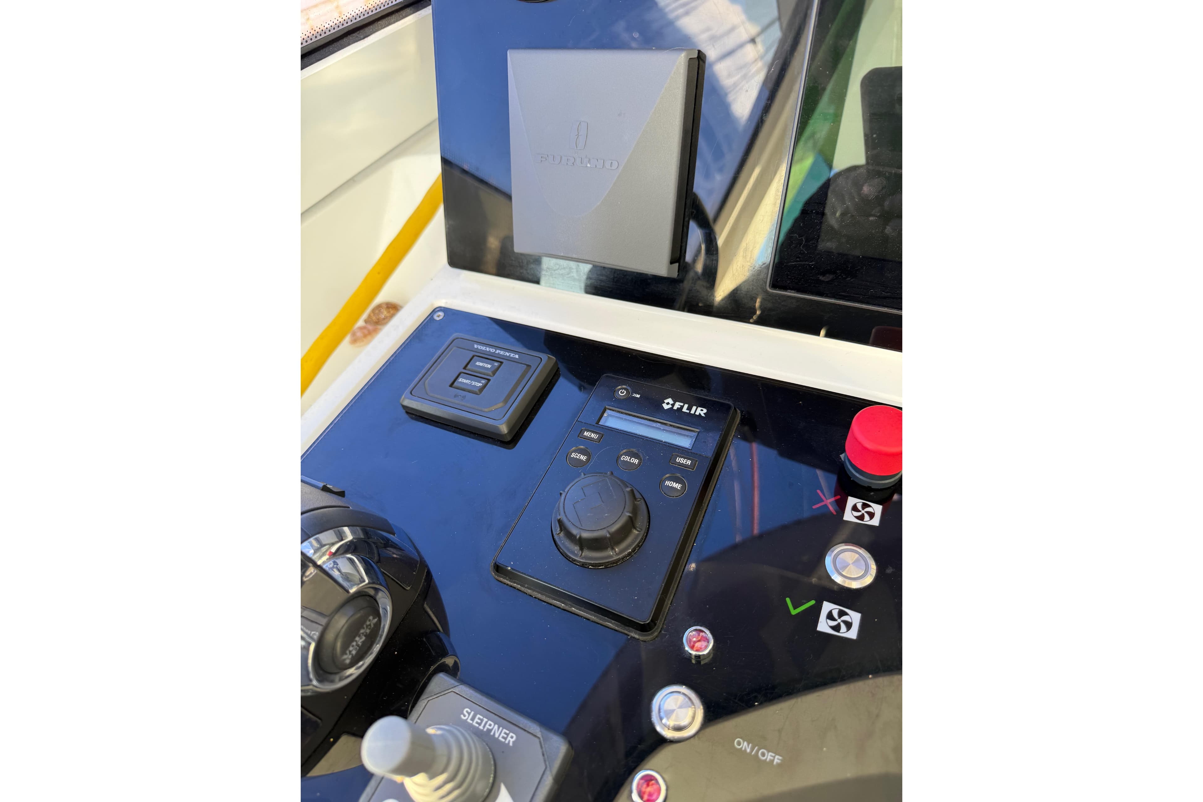 Control panel of a 2020 Amel 50 yacht featuring FLIR system and joystick controls.