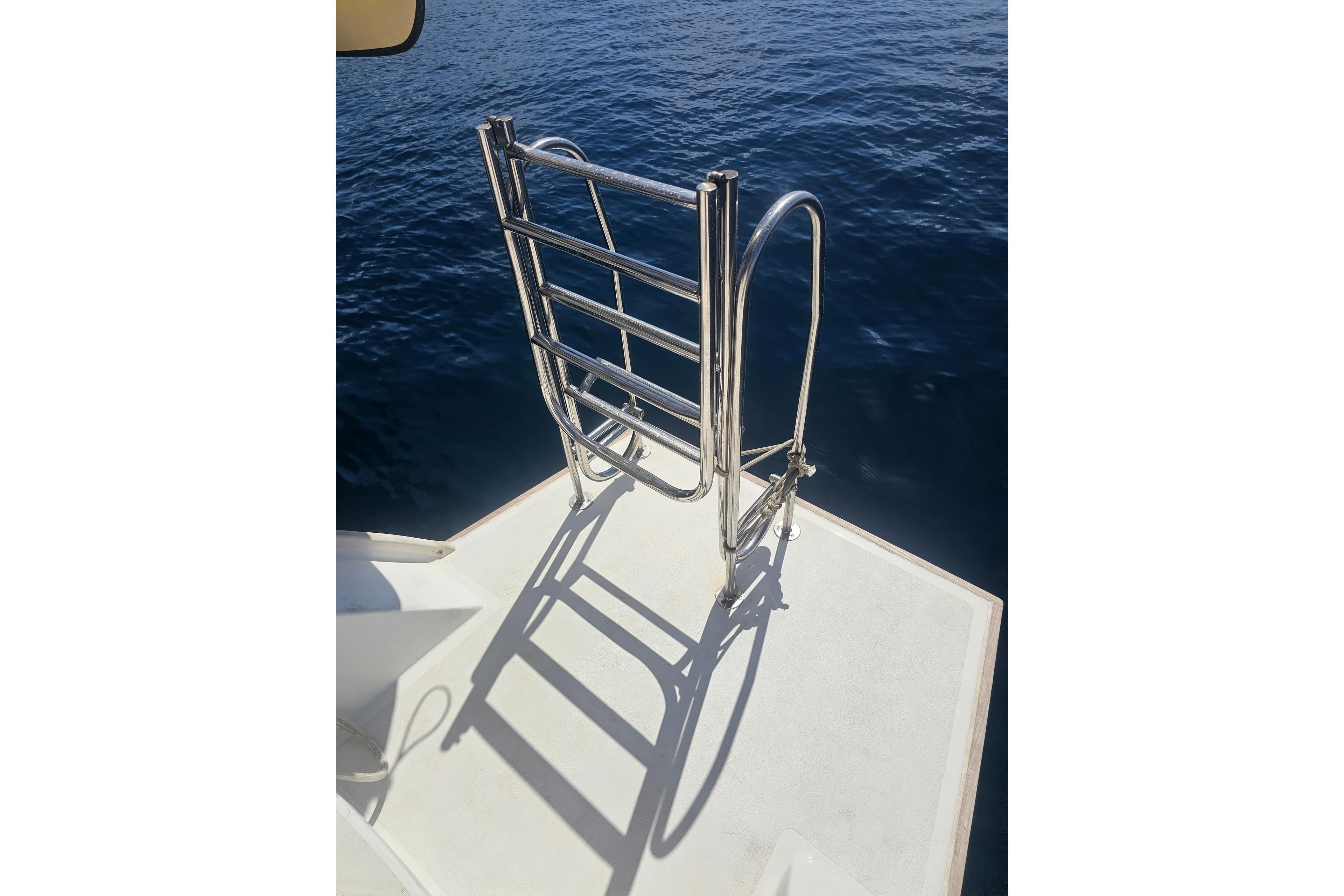 Stainless steel ladder on Lagoon 500 yacht, 2007, against deep blue sea.