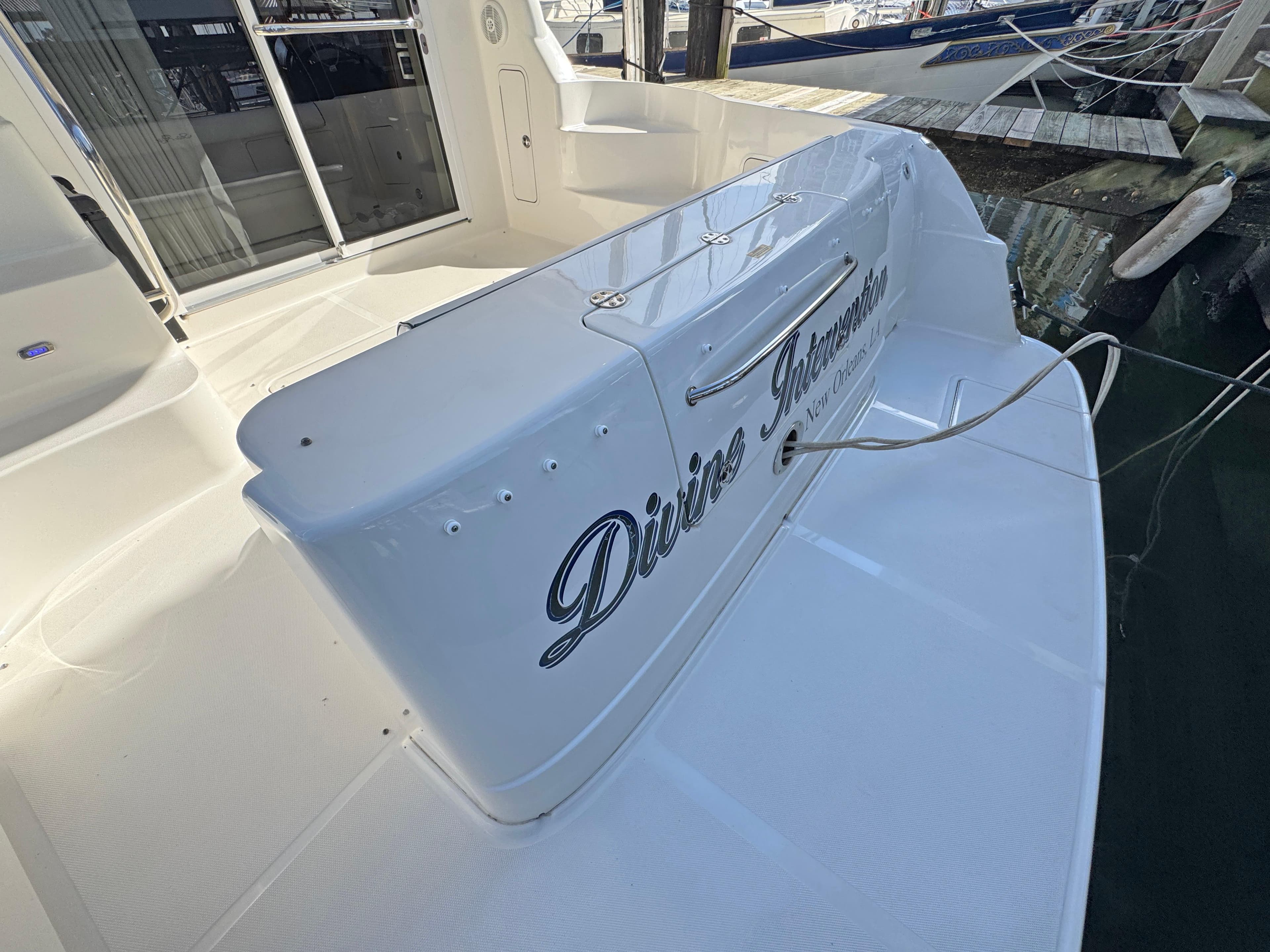 2007 Sea Ray 44 Sedan Bridge yacht, docked, featuring "Divine Intervention" name on stern.