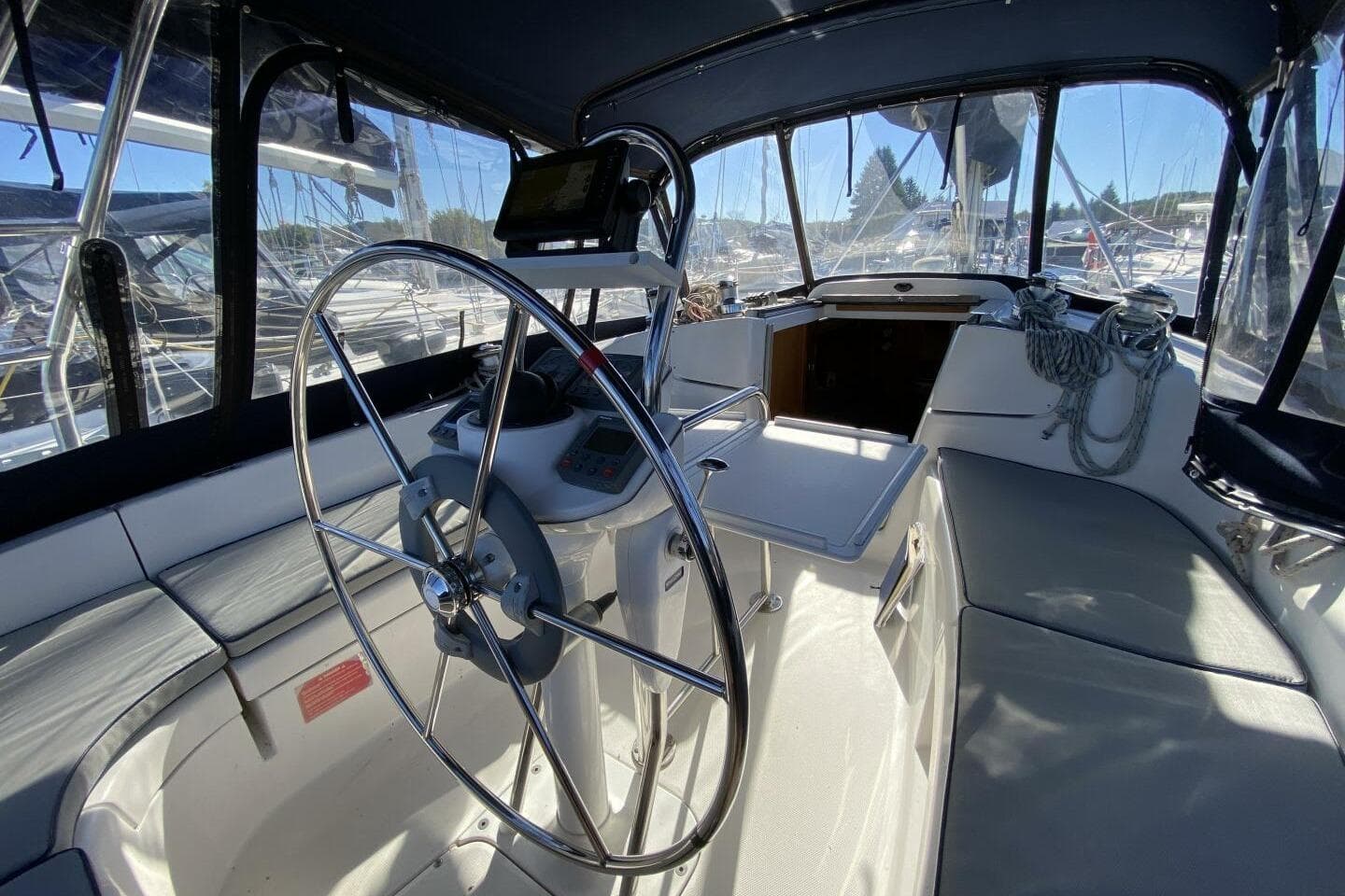 Interior of a 2003 Hunter 356 sailboat cockpit with steering wheel and seating.
