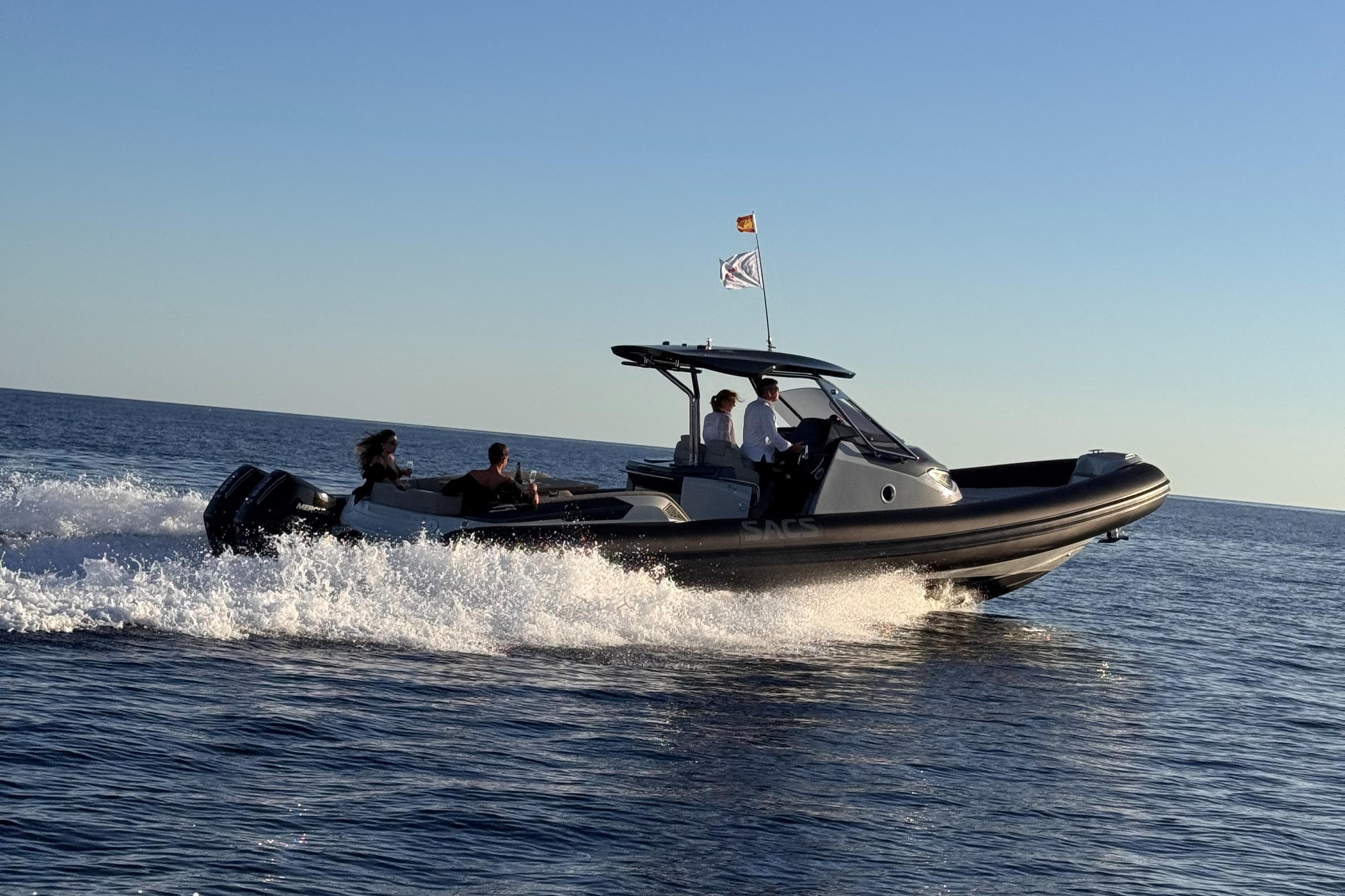 2025 SACS Strider 11 OB Sundeck cruising on open water at high speed.