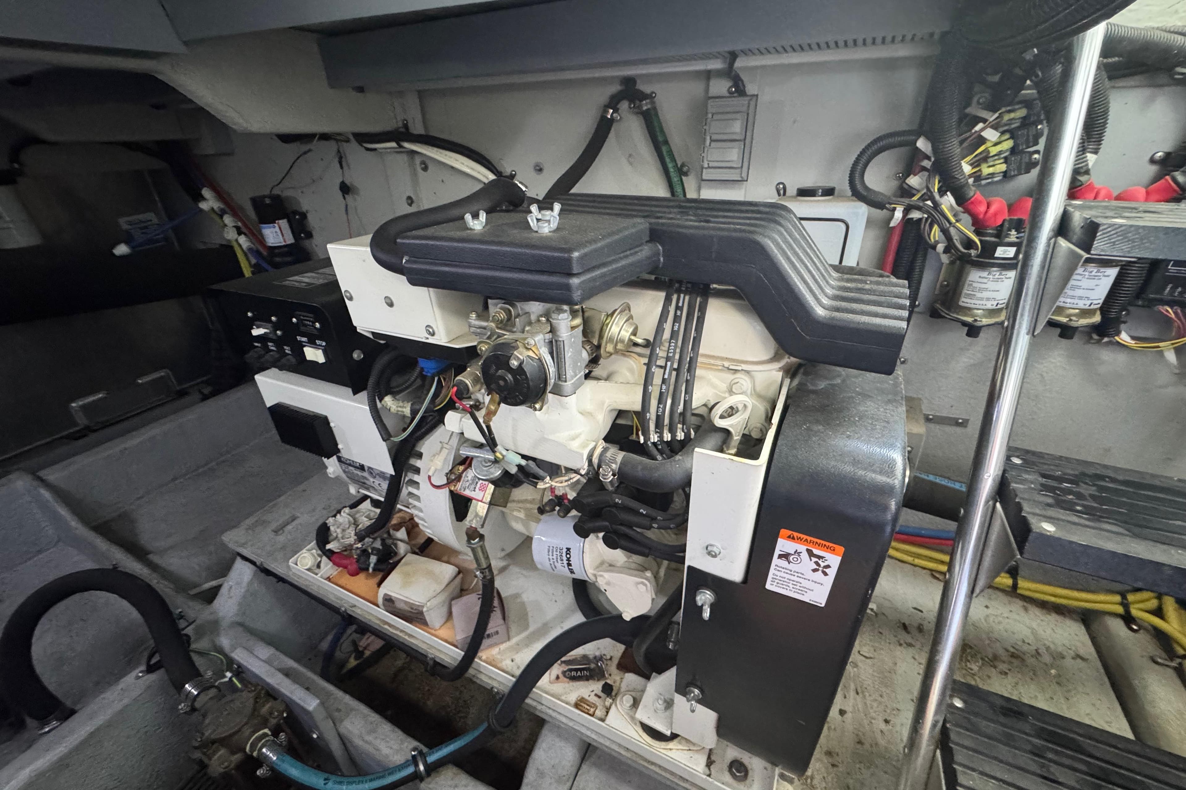 Engine room of a 2003 Meridian 411 Sedan yacht, showcasing mechanical components and wiring.