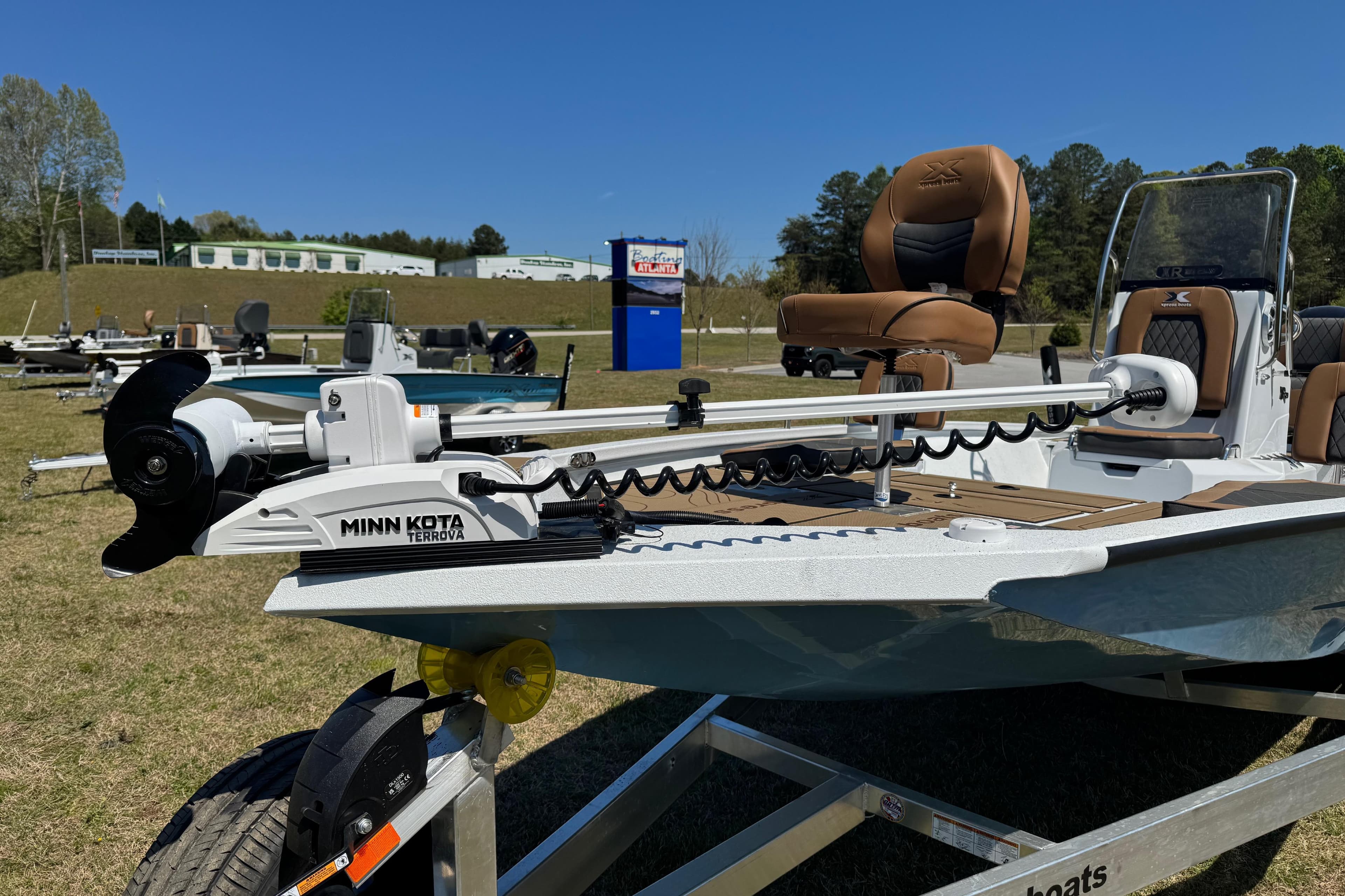 2026 Xpress XR21 Bay boat with Minn Kota Terrova motor on display outdoors.