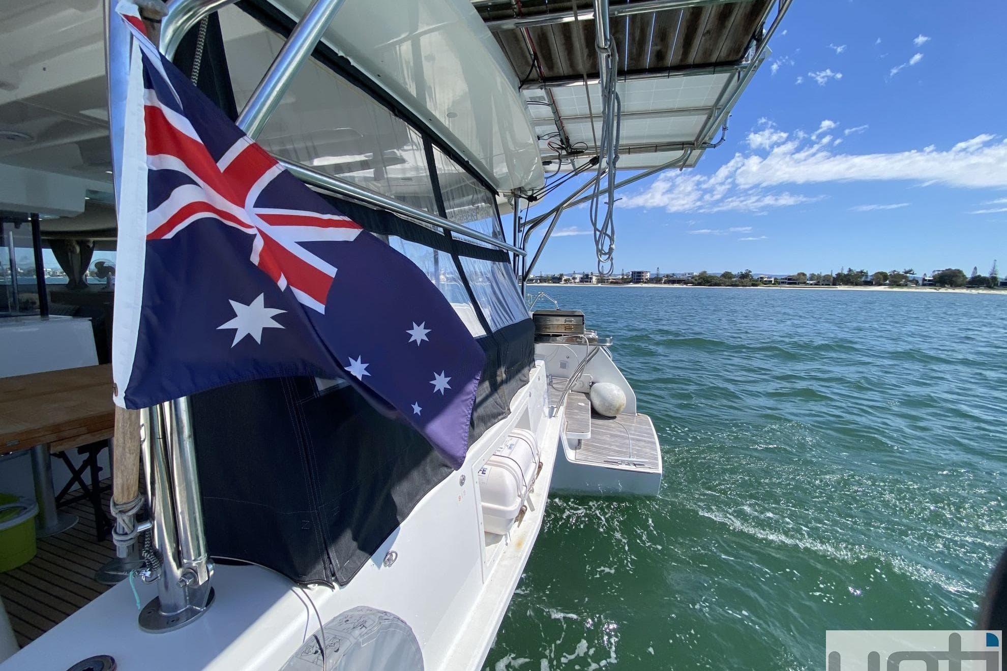 2022 Lagoon 46 catamaran with Australian flag, sailing on clear blue waters.