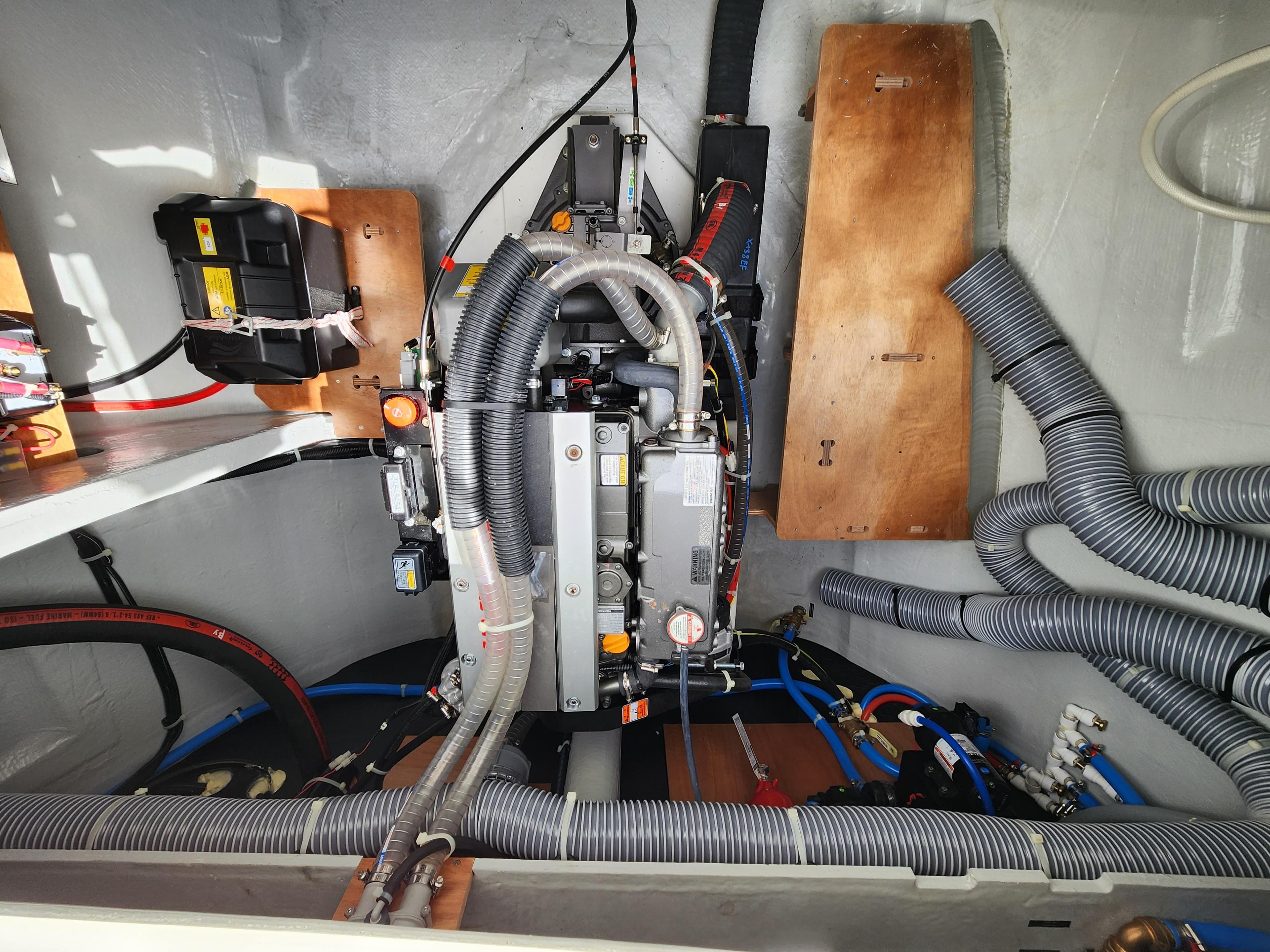 2024 Lagoon 46 engine compartment with wiring and hoses.