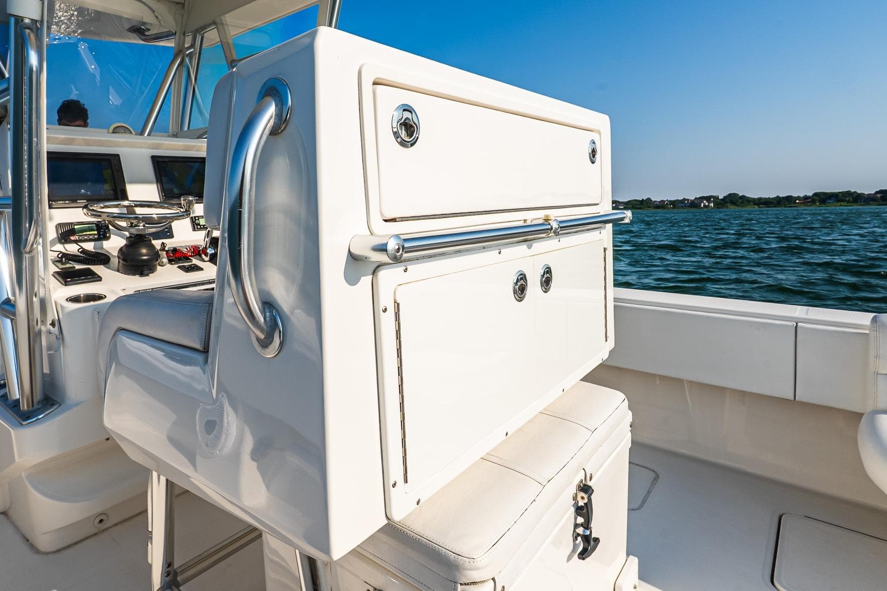 2016 Invincible 33 Open Fisherman boat interior with steering console, on calm water.