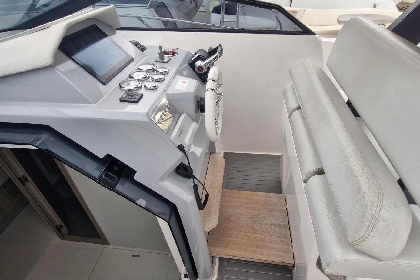 2022 RIO 34 Daytona boat helm with modern controls and seating.