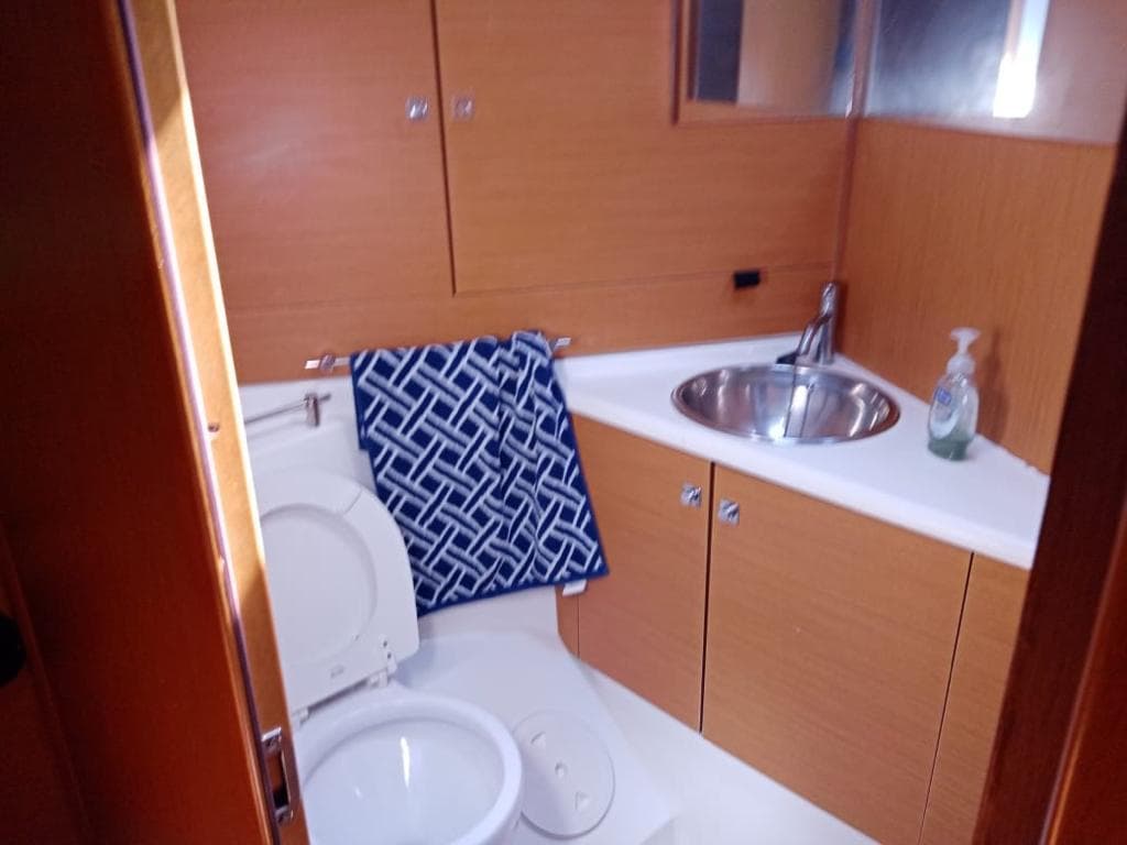 Bathroom interior of 2011 Jeanneau Sun Odyssey 45 yacht with sink and toilet.