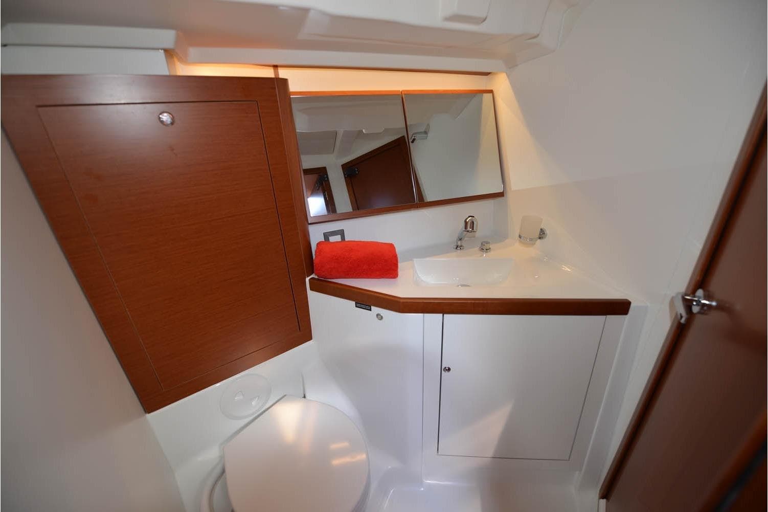 Bathroom interior of 2019 Beneteau Oceanis 46.1 yacht with wooden cabinetry and modern fixtures.