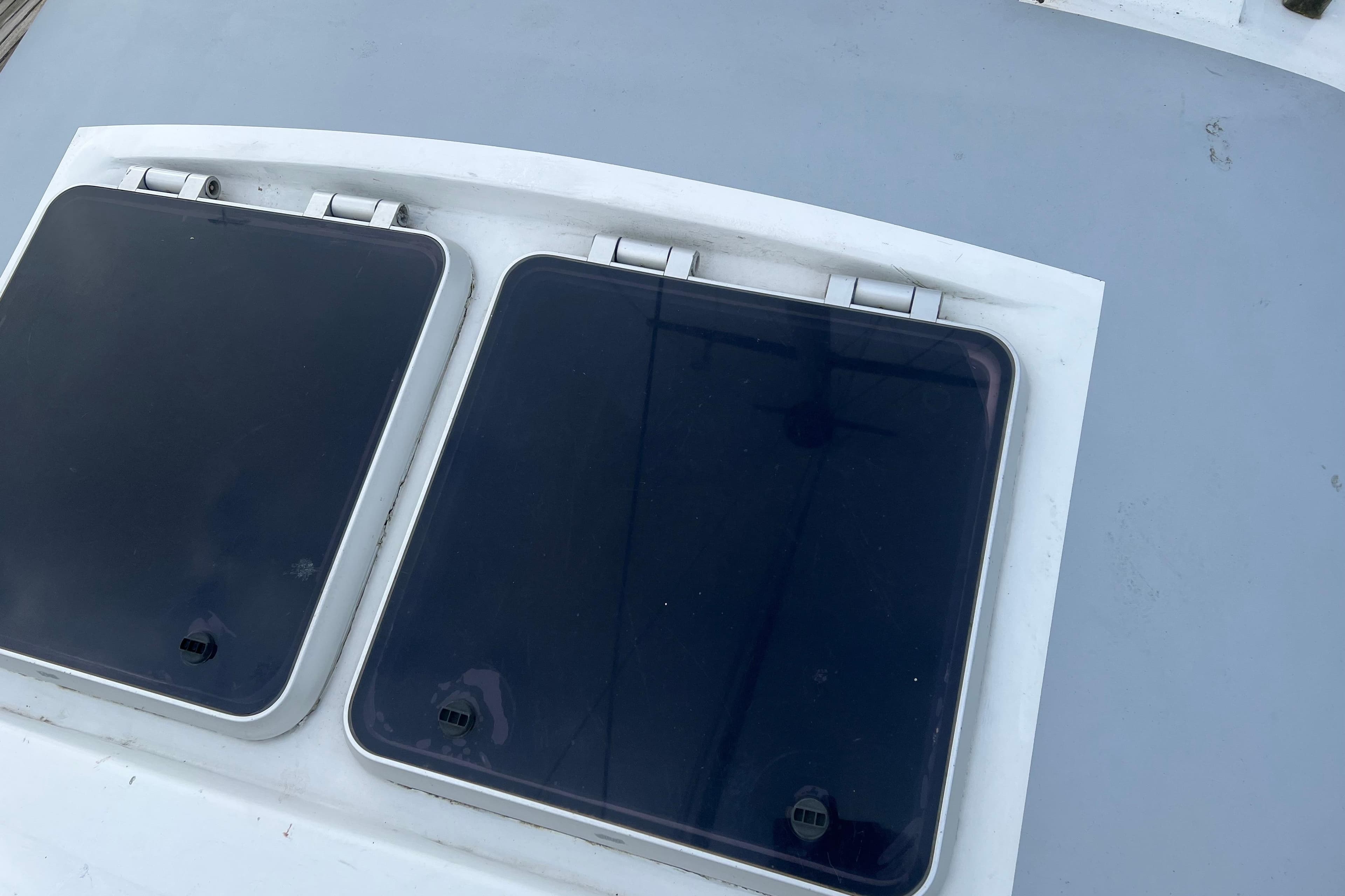 Deck hatches on a 1990 Trintella 49A sailboat, featuring sleek design and functionality.