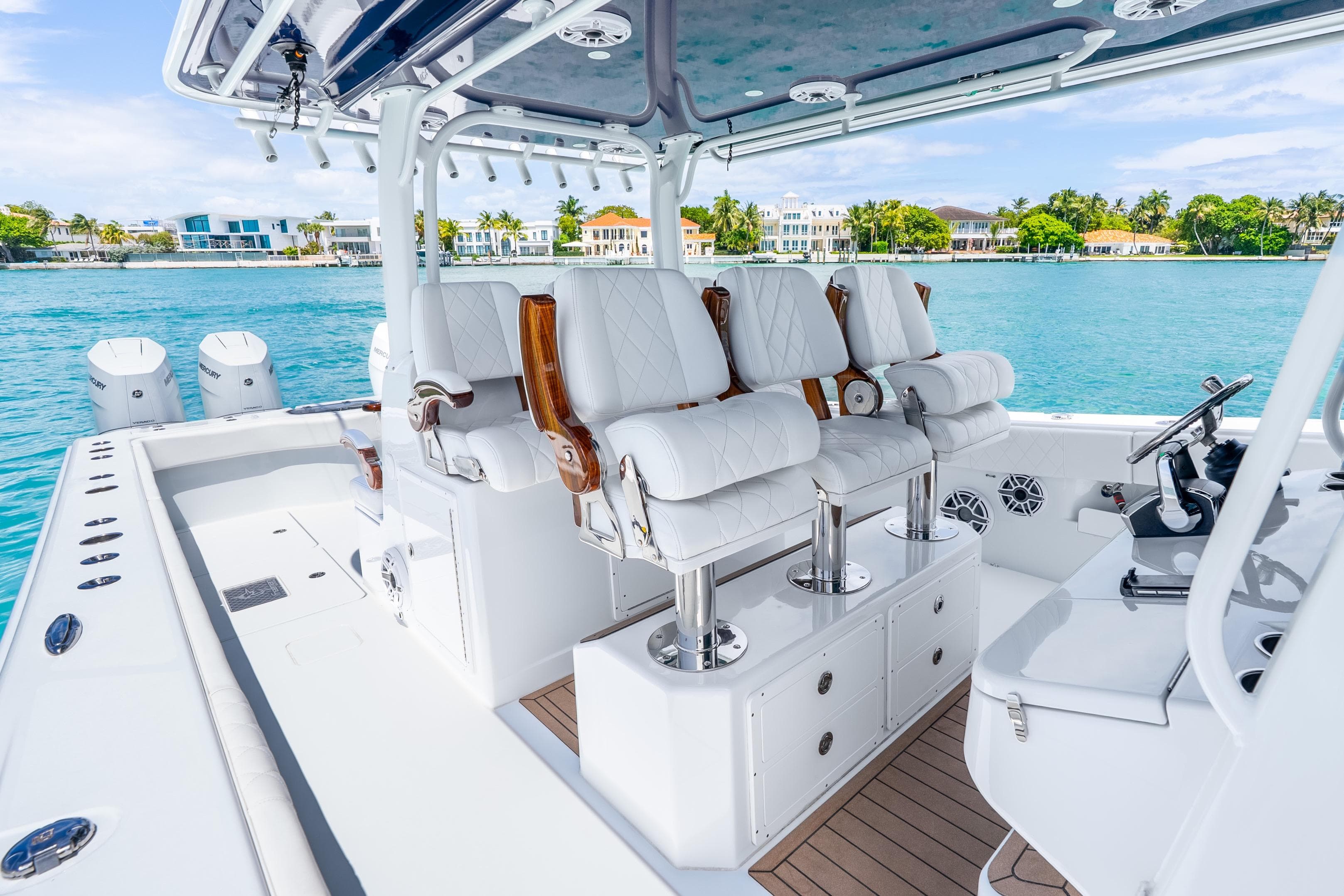 Luxurious 2025 Freeman 43 boat interior with plush seating, overlooking serene waterfront homes.