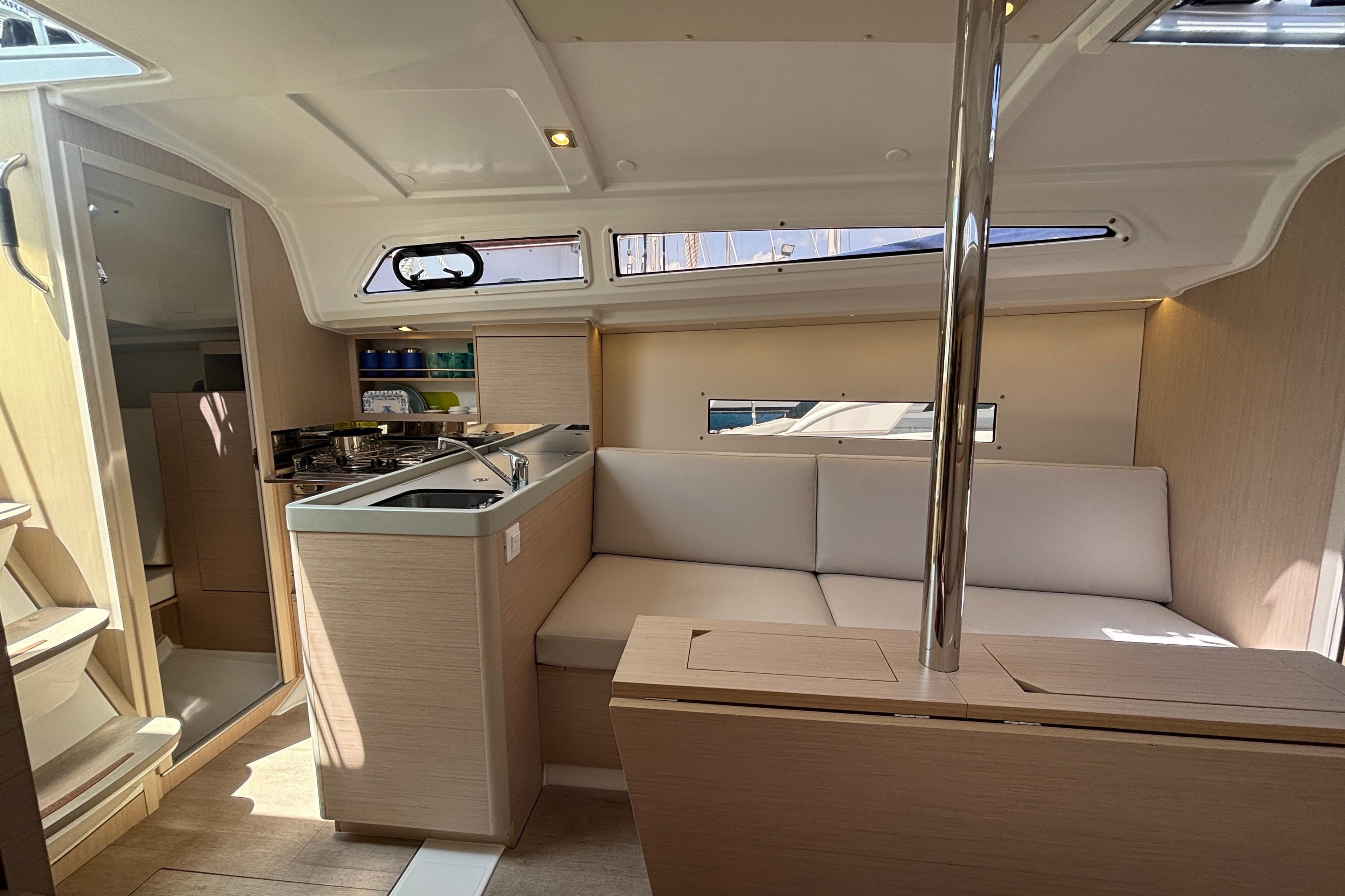 Interior of 2021 Beneteau Oceanis 30.1 yacht with modern kitchen and seating area.