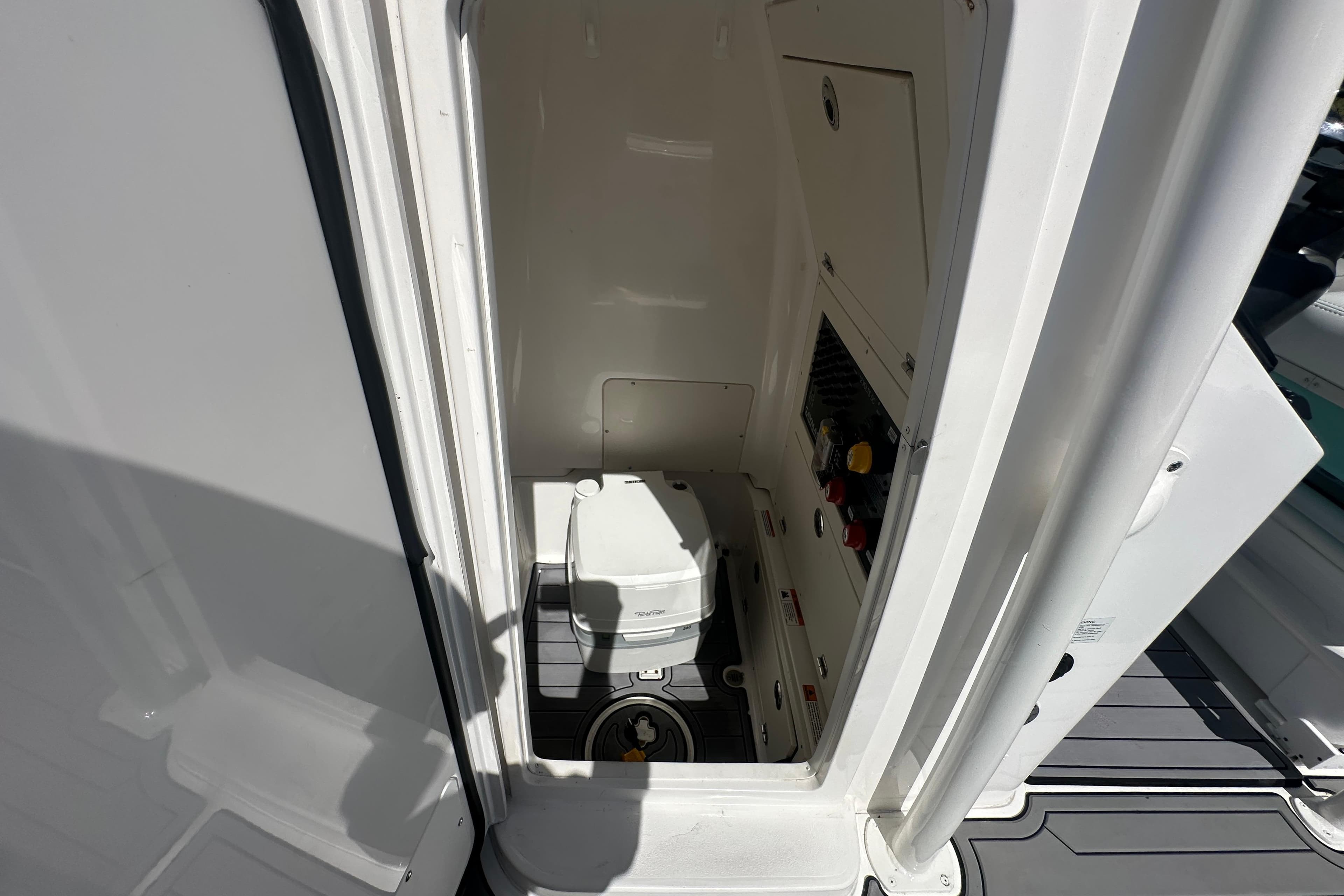 2021 Caymas 28 HB boat interior with compact marine toilet.