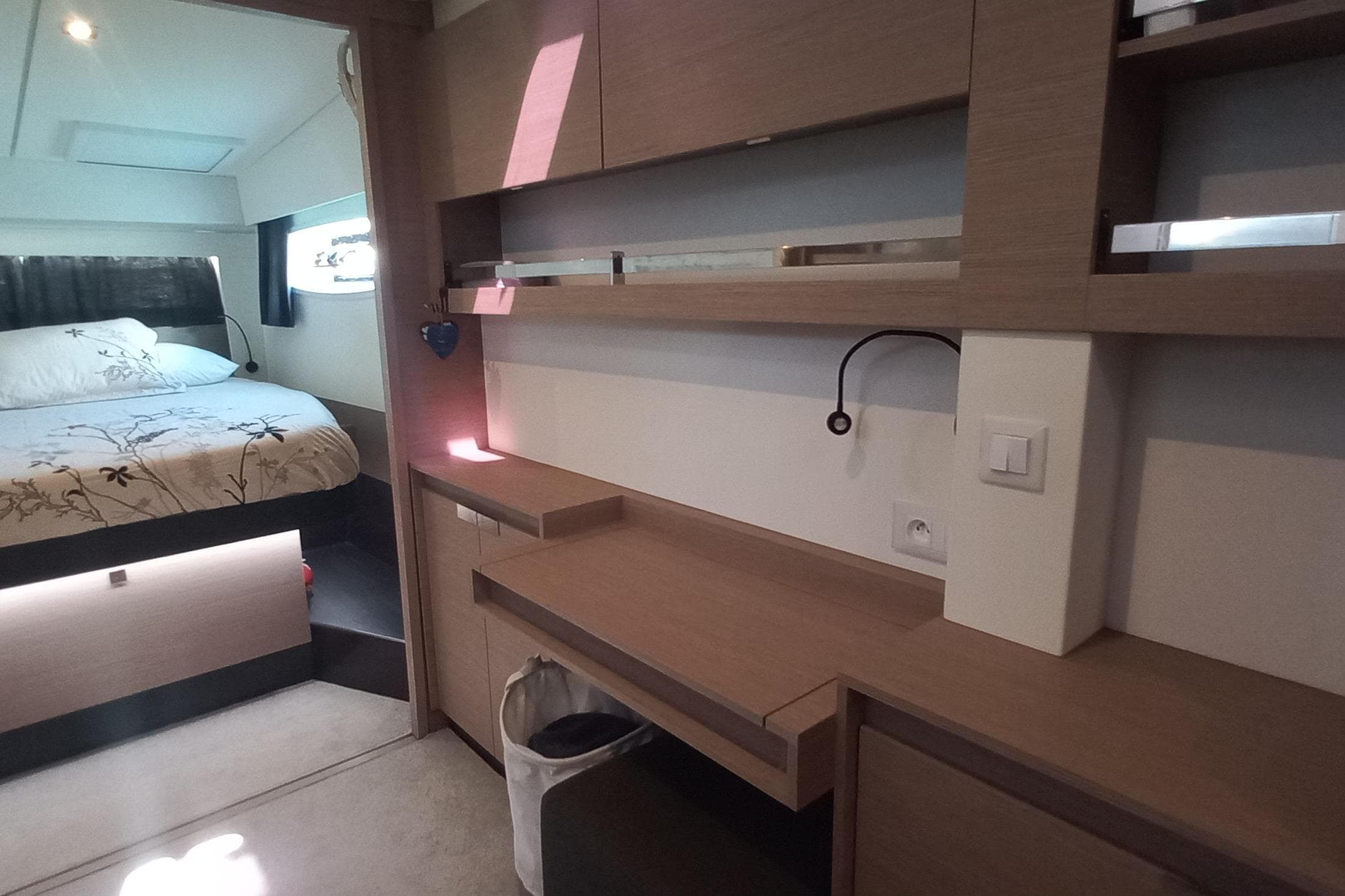 Interior of 2022 Fountaine Pajot Elba 45 Catamaran with modern bedroom and workspace.