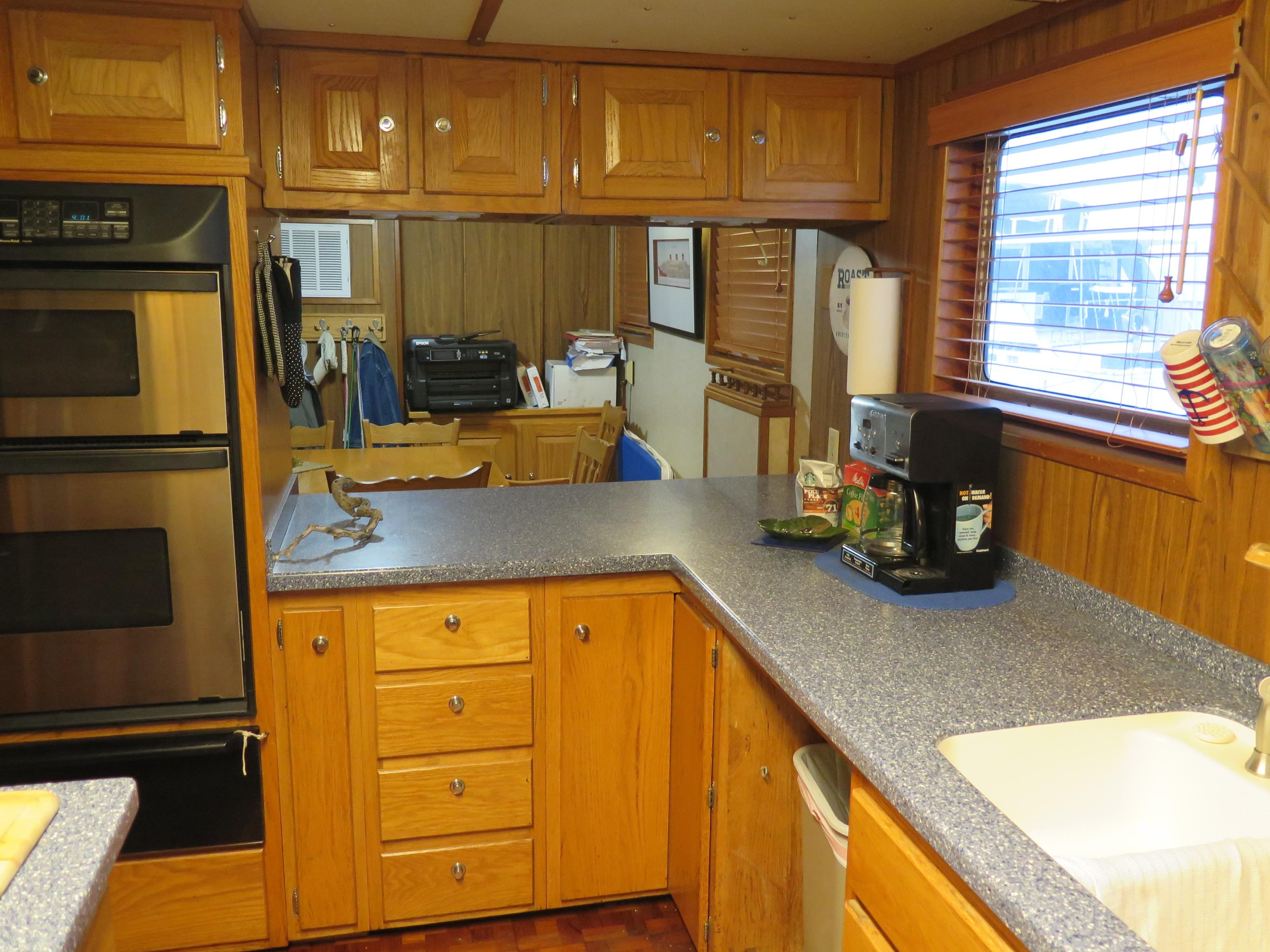 1998 Rodriquez Custom kitchen with wooden cabinets, double oven, and countertop appliances.