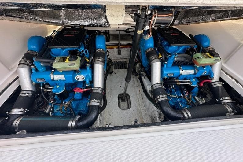 Engine compartment of a 2006 Tiara Yachts 2900 Coronet, featuring dual blue engines.