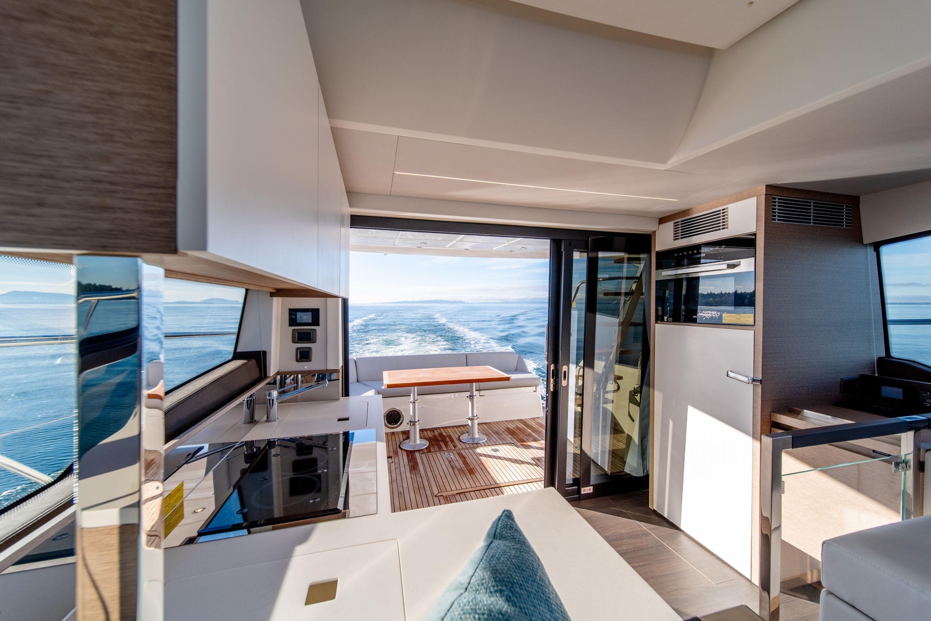 Luxurious interior of 2026 Prestige 460 yacht with modern kitchen and ocean view.