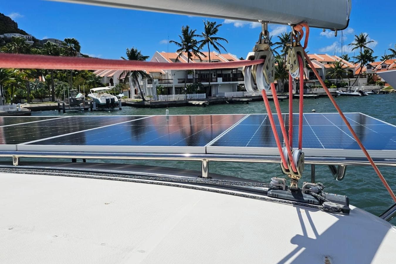 Sailboat with solar panels docked in a marina, Leopard 43 model, 2005.