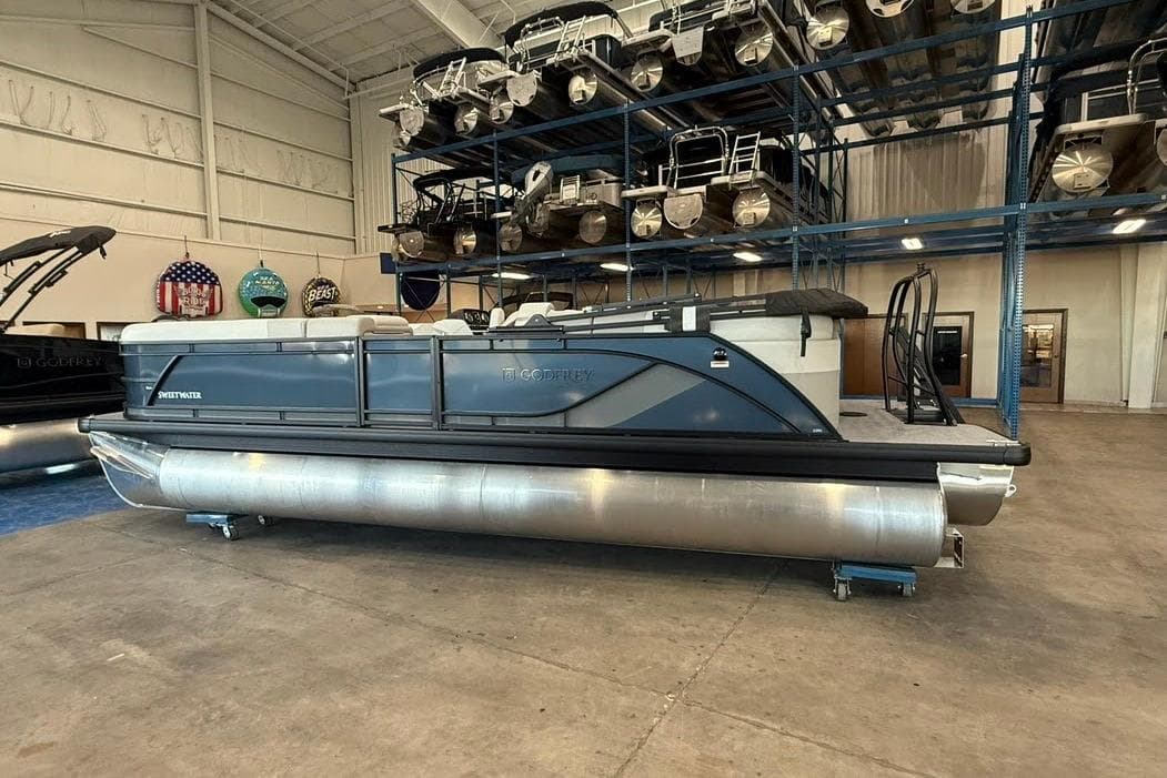 2026 Godfrey SWEETWATER 2286 SB pontoon boat in showroom, side view.