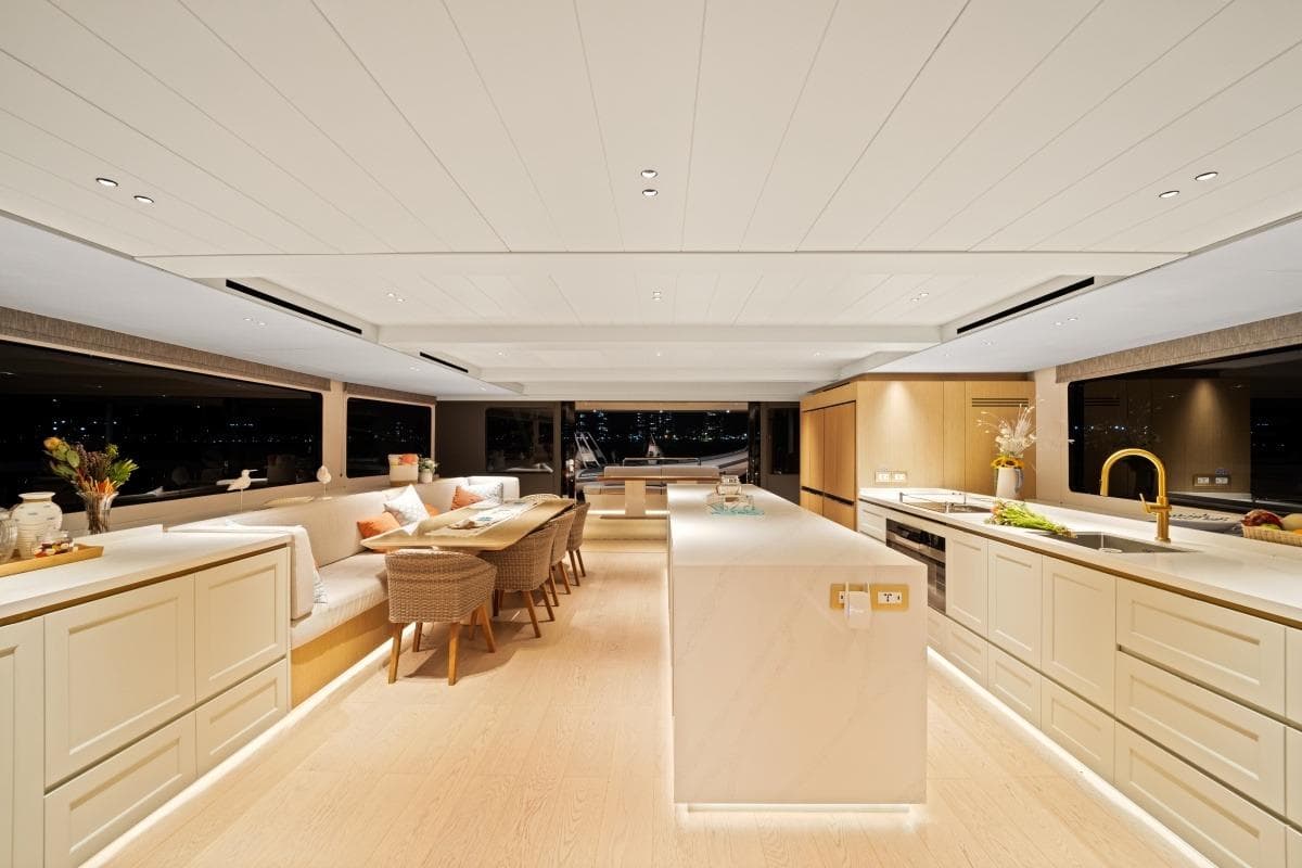Luxurious interior of 2023 McConaghy MC 82P yacht with modern kitchen and dining area.