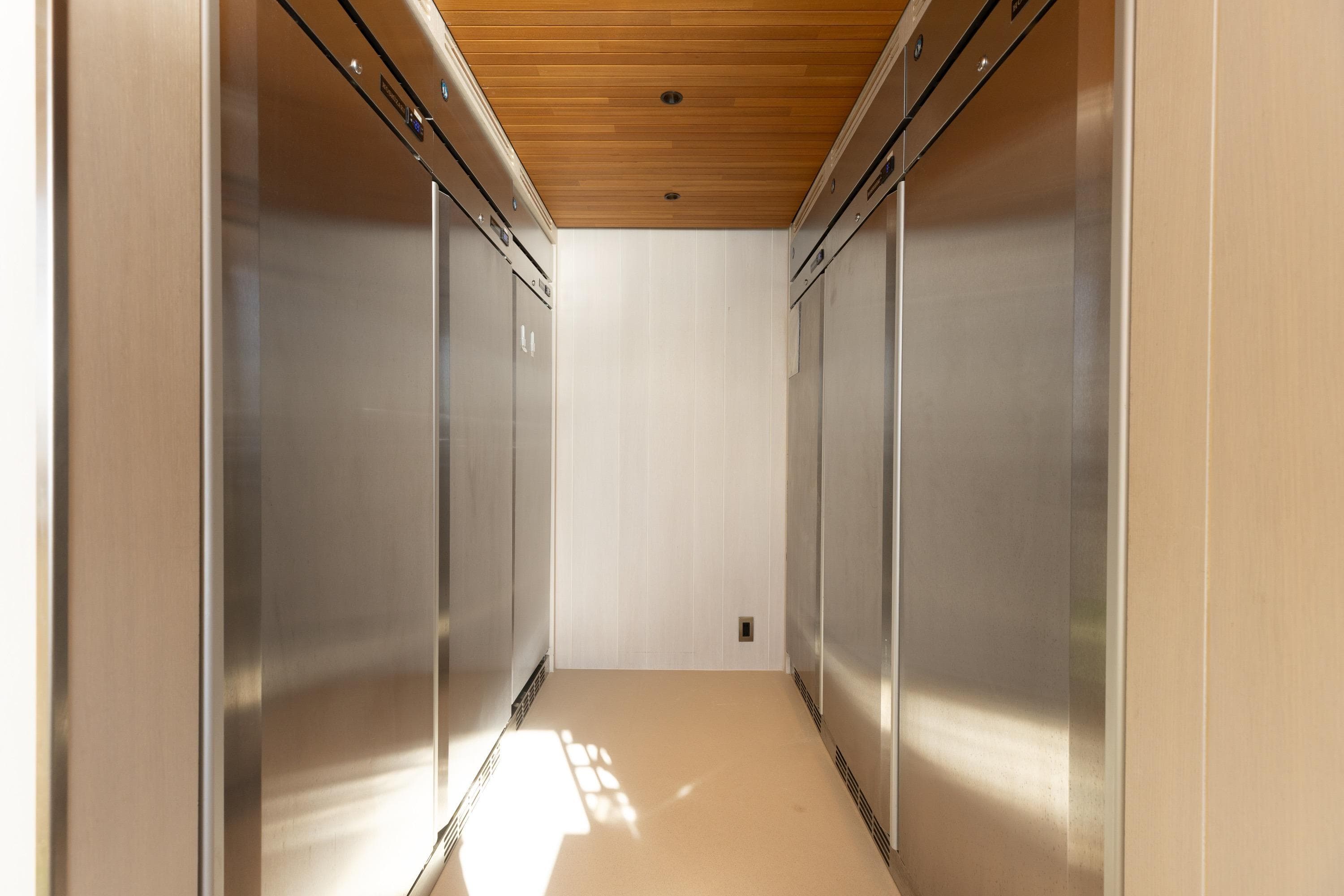 Modern stainless steel kitchen on 2024 Dunya Yachts Explorer, featuring sleek design and wood accents.