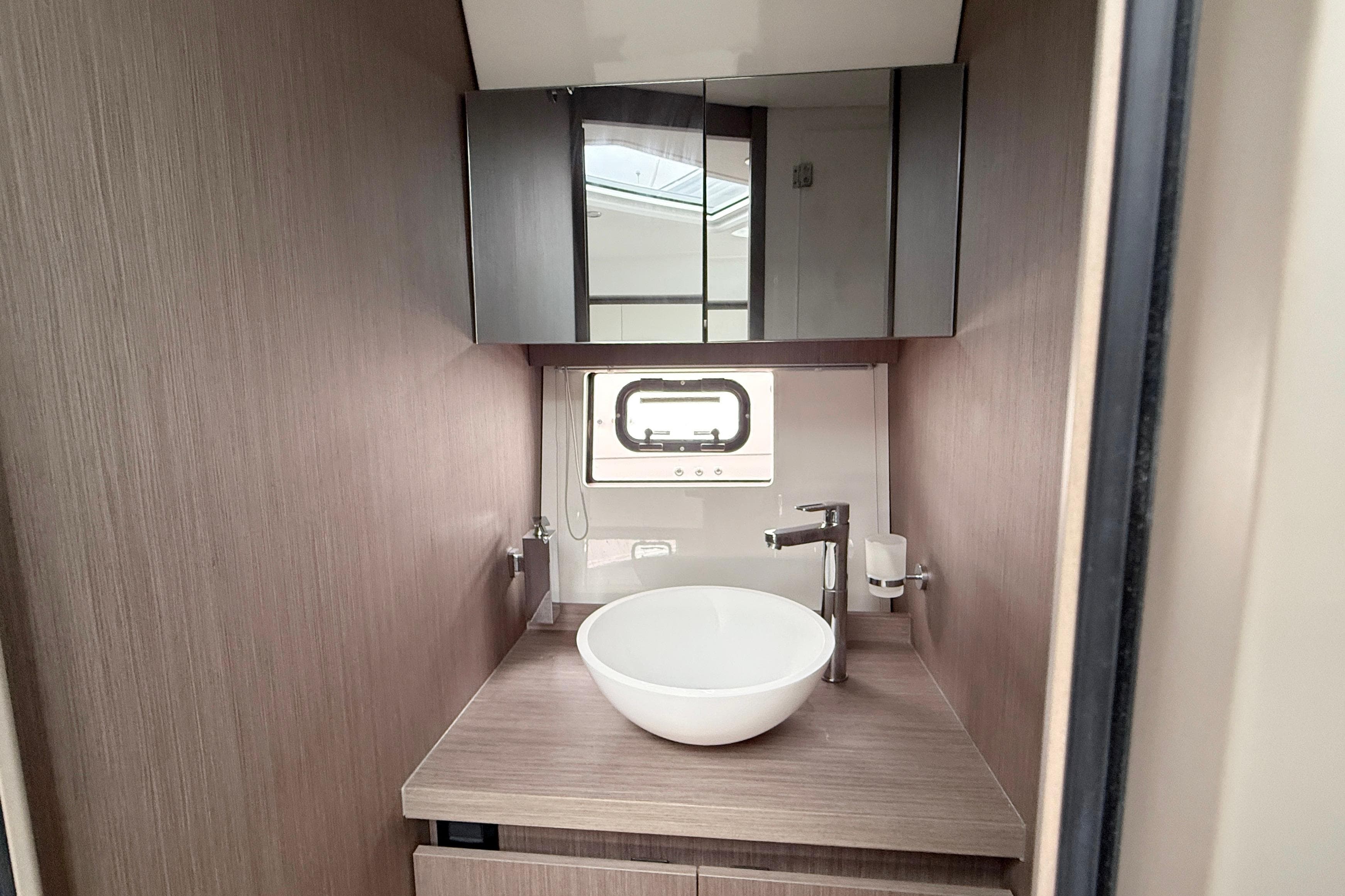 Modern bathroom interior of 2022 Beneteau Gran Turismo 41 yacht with sleek design.
