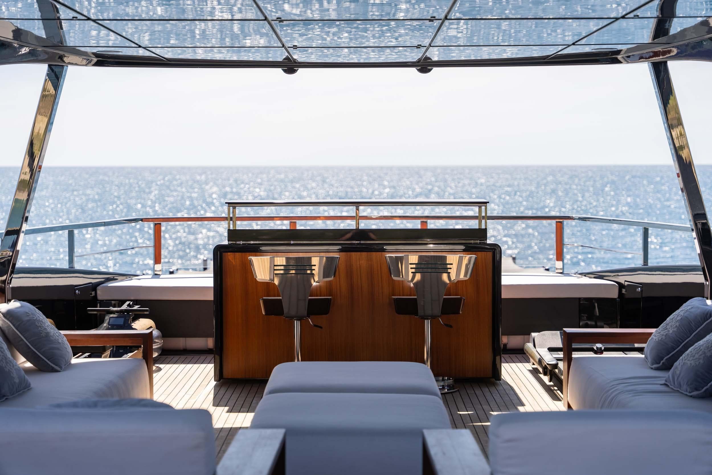 Luxurious 2023 Riva 130' Bellissima yacht deck with ocean view and elegant seating.