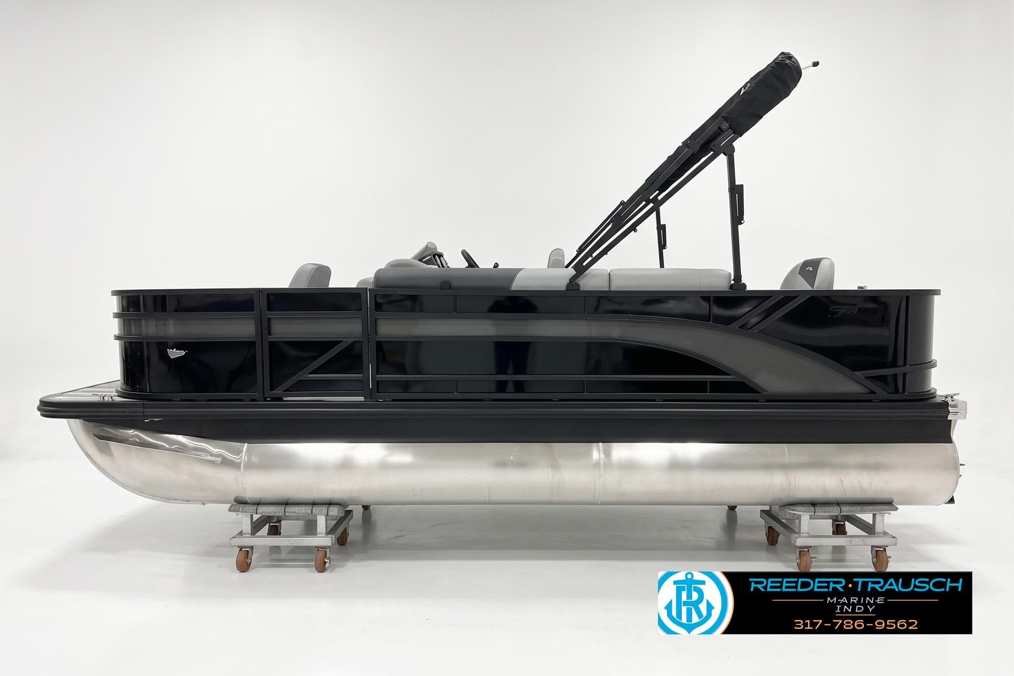 2026 Bennington 188 SF pontoon boat in sleek black, displayed in a showroom.