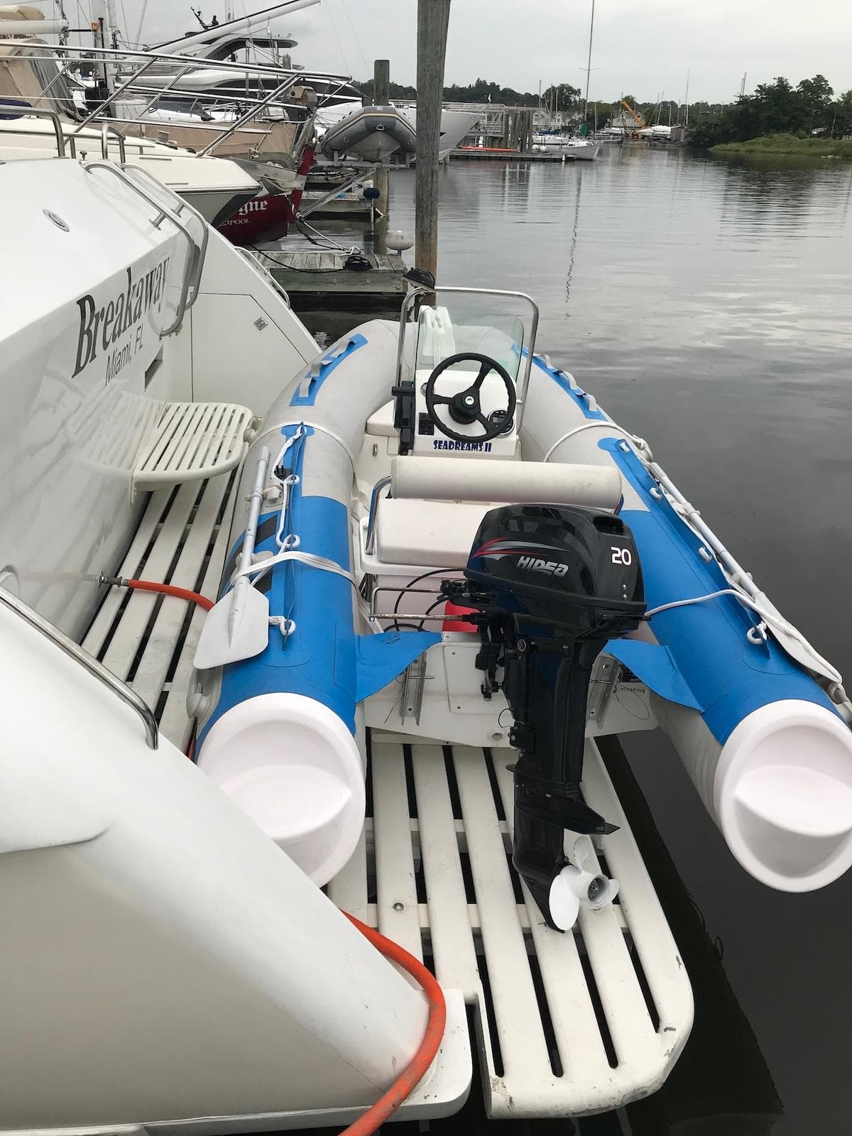 Inflatable boat with motor docked beside 1989 Birchwood 62 Cockpit Motor Yacht.