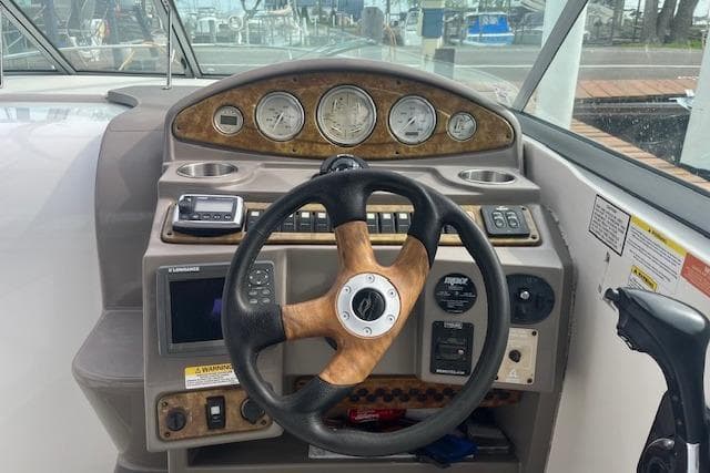 Steering console of a 2007 Rinker 280 Express Cruiser with gauges and controls.