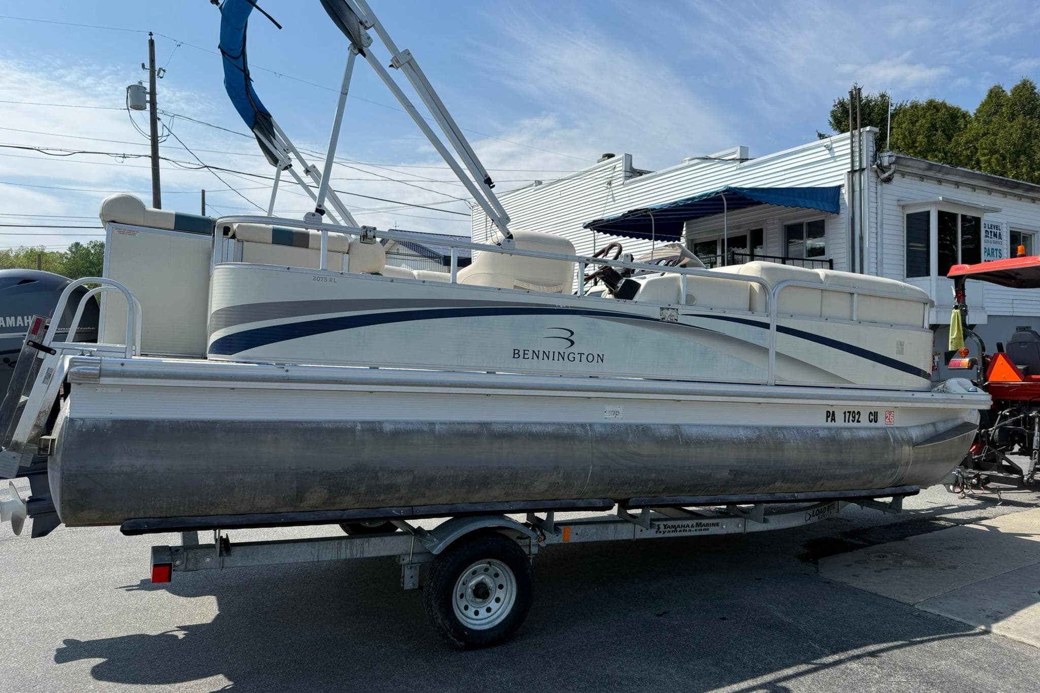 2005 Bennington 2075RL pontoon boat on trailer, parked outdoors.