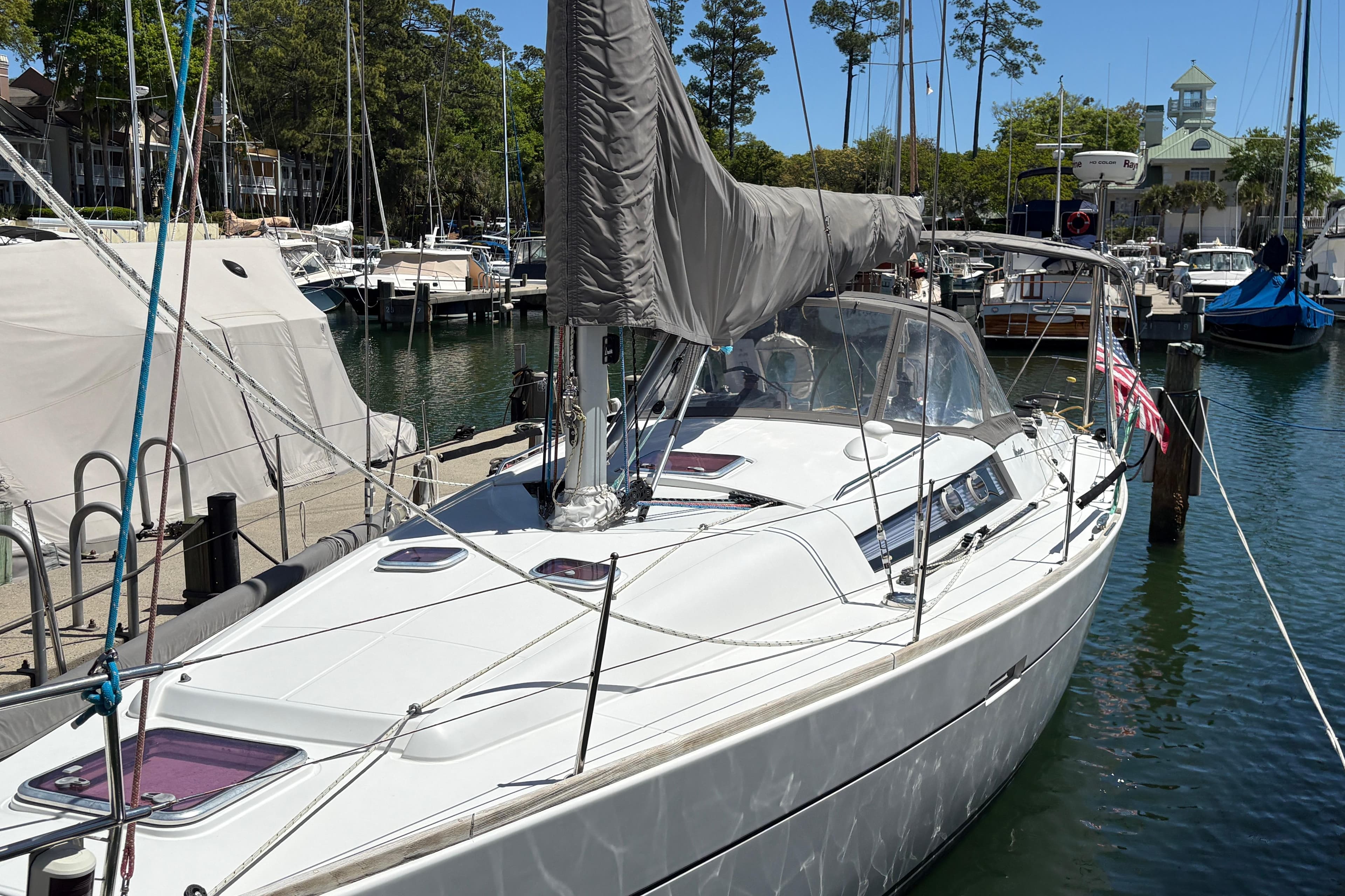 2008 Wauquiez Centurion 40s sailboat docked at a marina, surrounded by other boats.