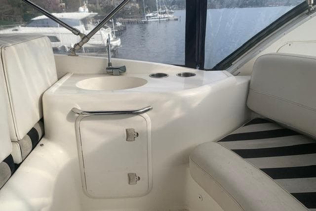 Interior of 2006 Meridian 411 Sedan yacht with seating and sink area.