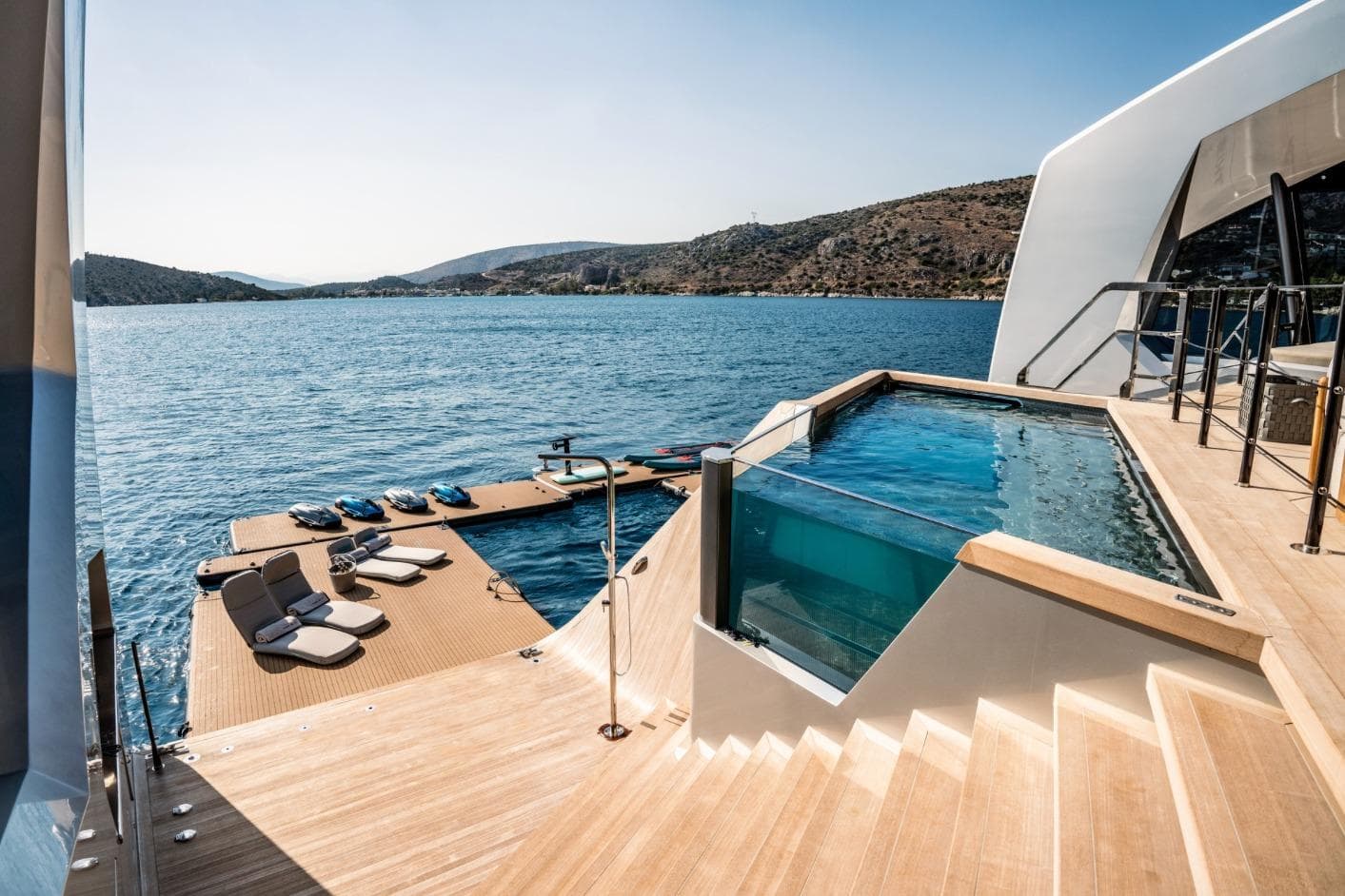 Luxurious 2024 Tecnomar Custom yacht with pool and sun deck on serene waters.