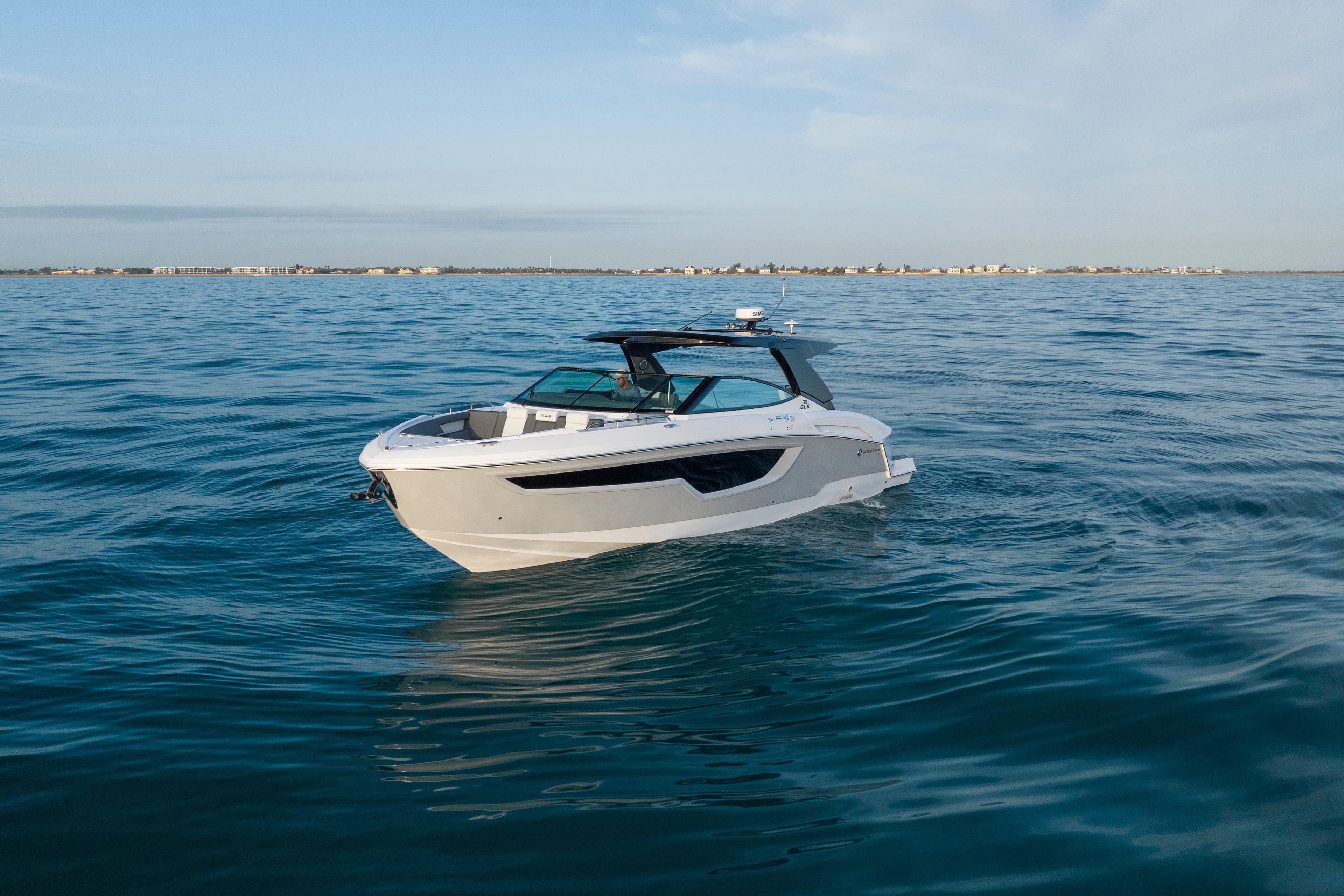 2026 Cruisers Yachts 38 GLS OB on calm ocean waters, showcasing sleek design.