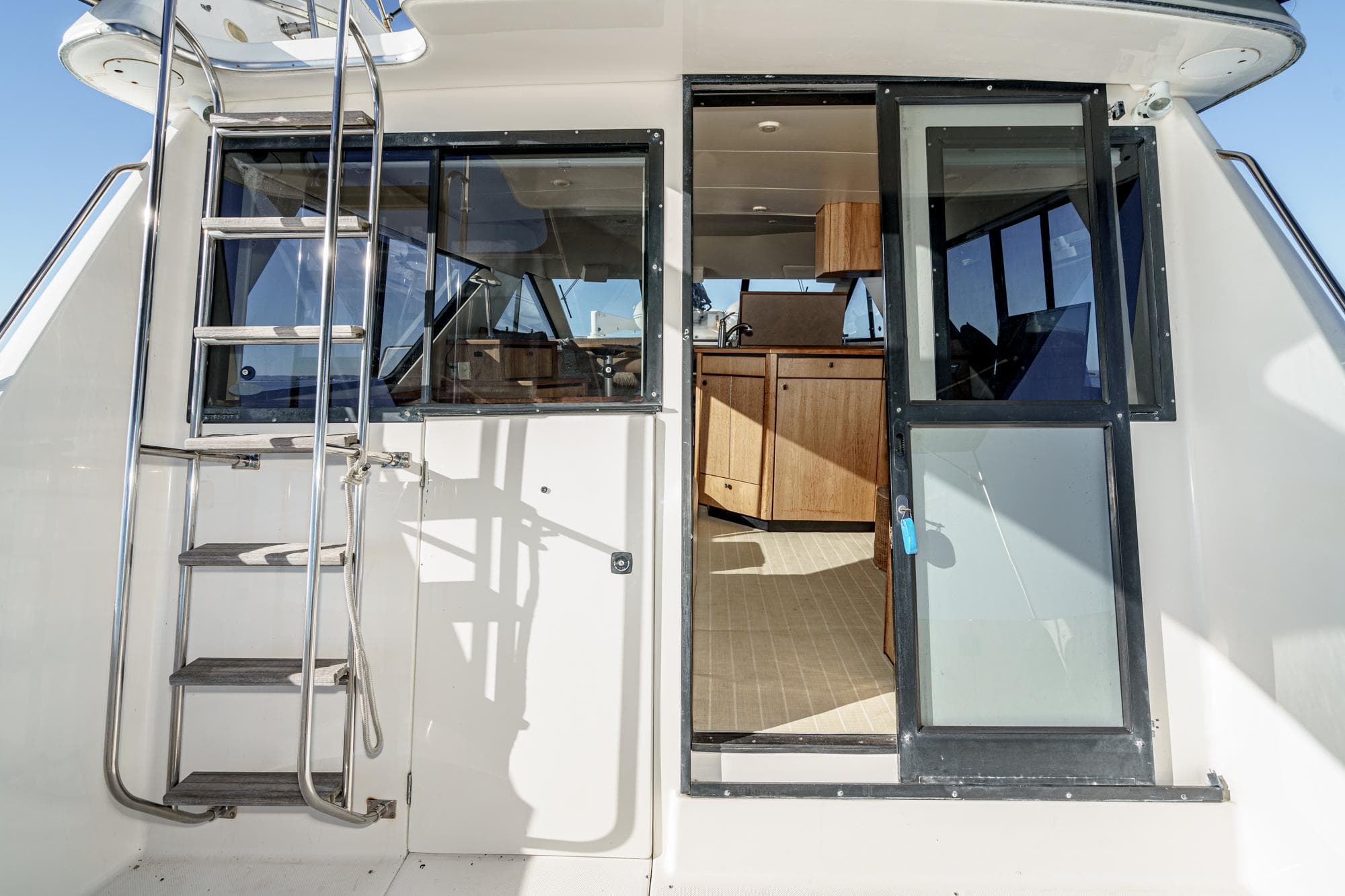 1998 Bayliner 3988 Motoryacht with open cabin door and exterior ladder.