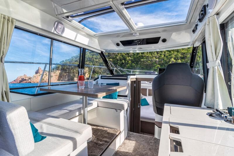 Manufacturer Provided Image: Interior of 2026 Jeanneau NC 895 Series 2 boat with panoramic windows and modern seating.