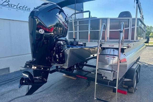 2026 Barletta A20L pontoon boat with Mercury outboard motor on trailer.